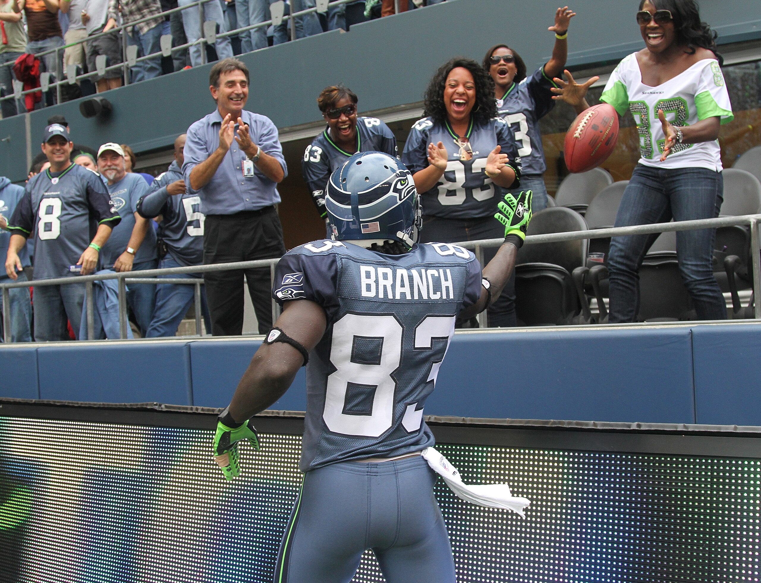 SEATTLE - SEPTEMBER 26:  Wide receiver Deion Branch #83 of the Seattle Seahawks tosses the ball to fans after scoring a touchdown against the San Diego Chargers at Qwest Field on September 26, 2010 in Seattle, Washington. The Seahawks defeated the Charger
