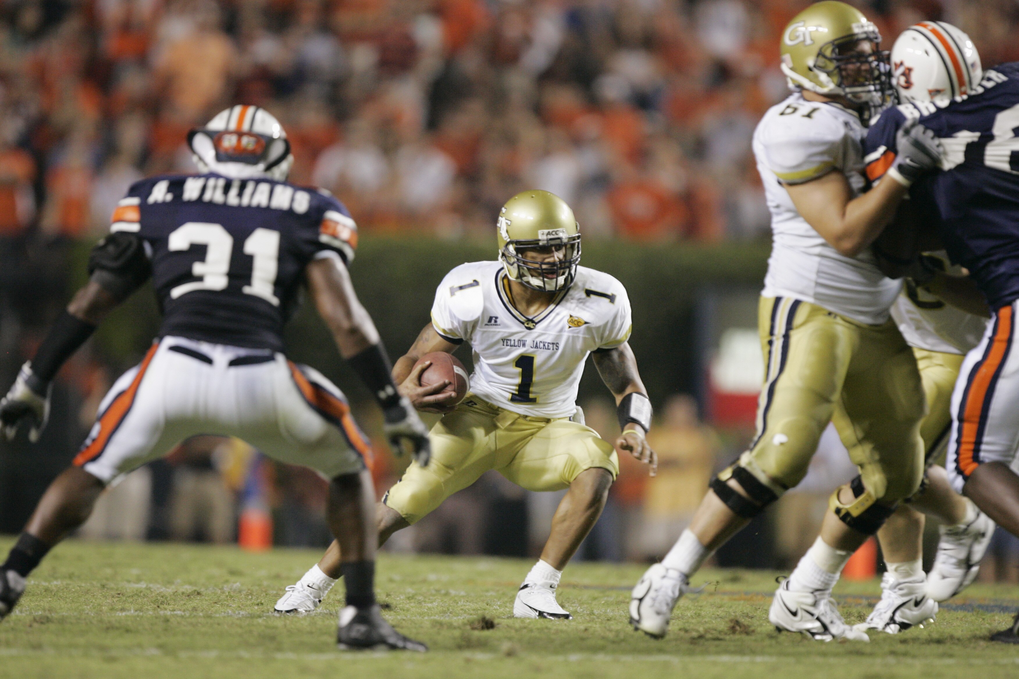 AUBURN, AL - SEPTEMBER 3:  Quarterback Reggie Ball #1 of the Georgia Tech Yellow Jackets scrambles while being defended by Antarrious Williams #31 of the Auburn Tigers during the game on September 3, 2005 at Jordan-Hare Stadium in Auburn, Alabama.  Georgi