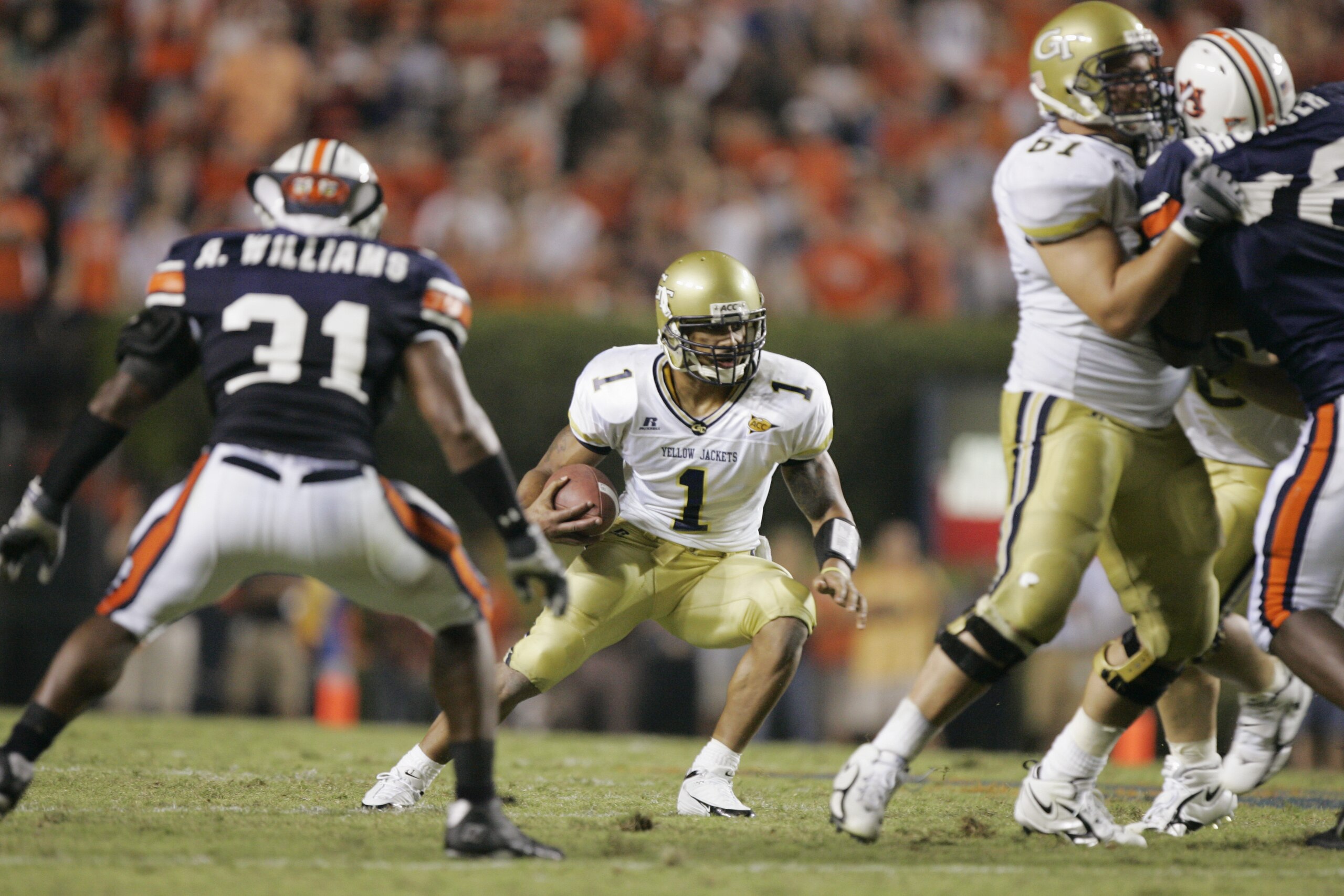 AUBURN, AL - SEPTEMBER 3: Quarterback Reggie Ball #1 of the Georgia Tech Yellow Jackets scrambles while being defended by Antarrious Williams #31 of the Auburn Tigers during the game on September 3, 2005 at Jordan-Hare Stadium in Auburn, Alabama. Georgi AUBURN, AL - SEPTEMBER 3: Quarterback Reggie Ball #1 of the Georgia Tech Yellow Jackets scrambles while being defended by Antarrious Williams #31 of the Auburn Tigers during the game on September 3, 2005 at Jordan-Hare Stadium in Auburn, Alabama. Georgi
