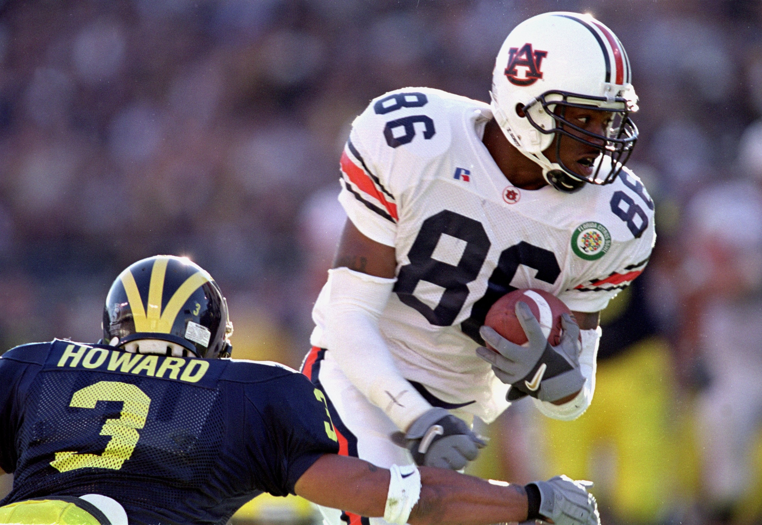 1 Jan 2001: Deandre Green #89 of the Auburn Tigers carries the ball as he avoids the tackle during the Citrus Bowl Game against the Michigan Wolverines at the Citrus Bowl in Orlando, Florida. The Wolverines defeated the Tiger 31-28.Mandatory Credit: An 1 Jan 2001: Deandre Green #89 of the Auburn Tigers carries the ball as he avoids the tackle during the Citrus Bowl Game against the Michigan Wolverines at the Citrus Bowl in Orlando, Florida. The Wolverines defeated the Tiger 31-28.Mandatory Credit: An