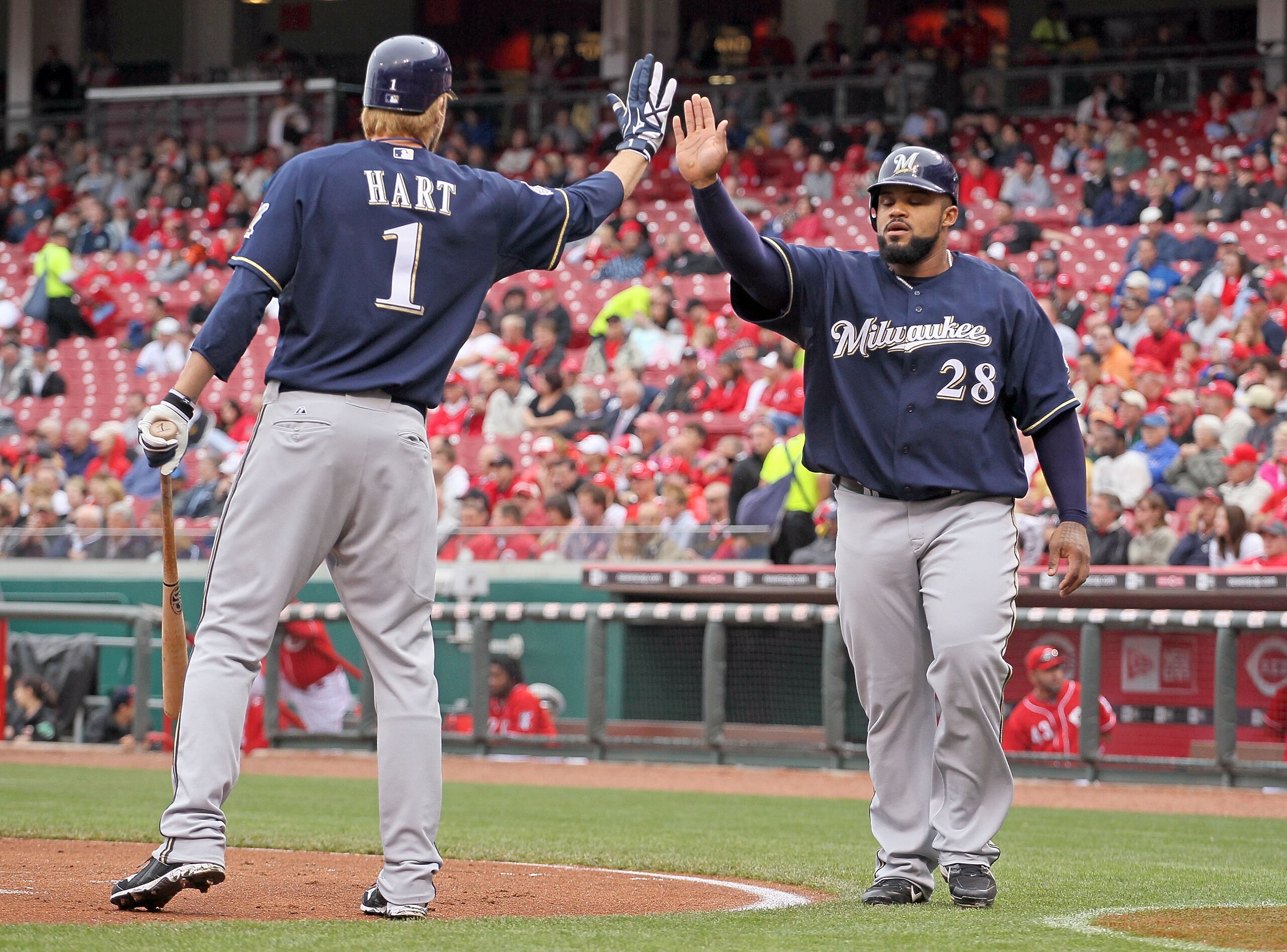 CINCINNATI - MAY 18:  Prince Fielder #28 of the Milwaukee Brewers is congratulated by Corey Hart #1 after Fielder scored in the first inning during the game against the Cincinnati Reds at Great American Ball Park on May 18, 2010 in Cincinnati, Ohio.  (Pho