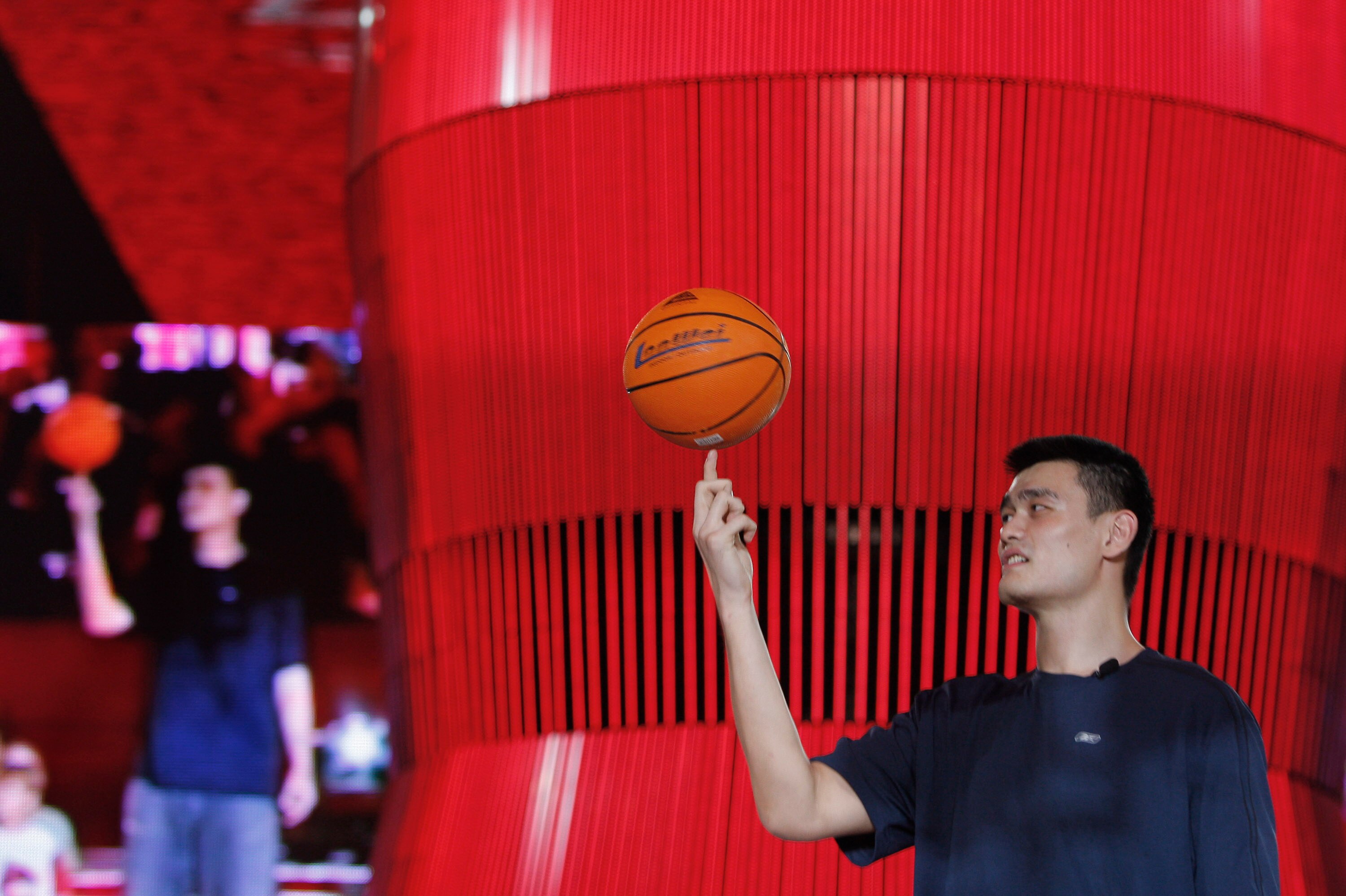 BEIJING, CHINA-AUGUST 21:China's Olympic basketball star Yao Ming shows off some talents along side USA's LeBron James at the Olympic Shuang Zone August 21, 2008 in Beijing. The Shuang Zone, sponsored by Coca Cola allows locals to attend free concerts off