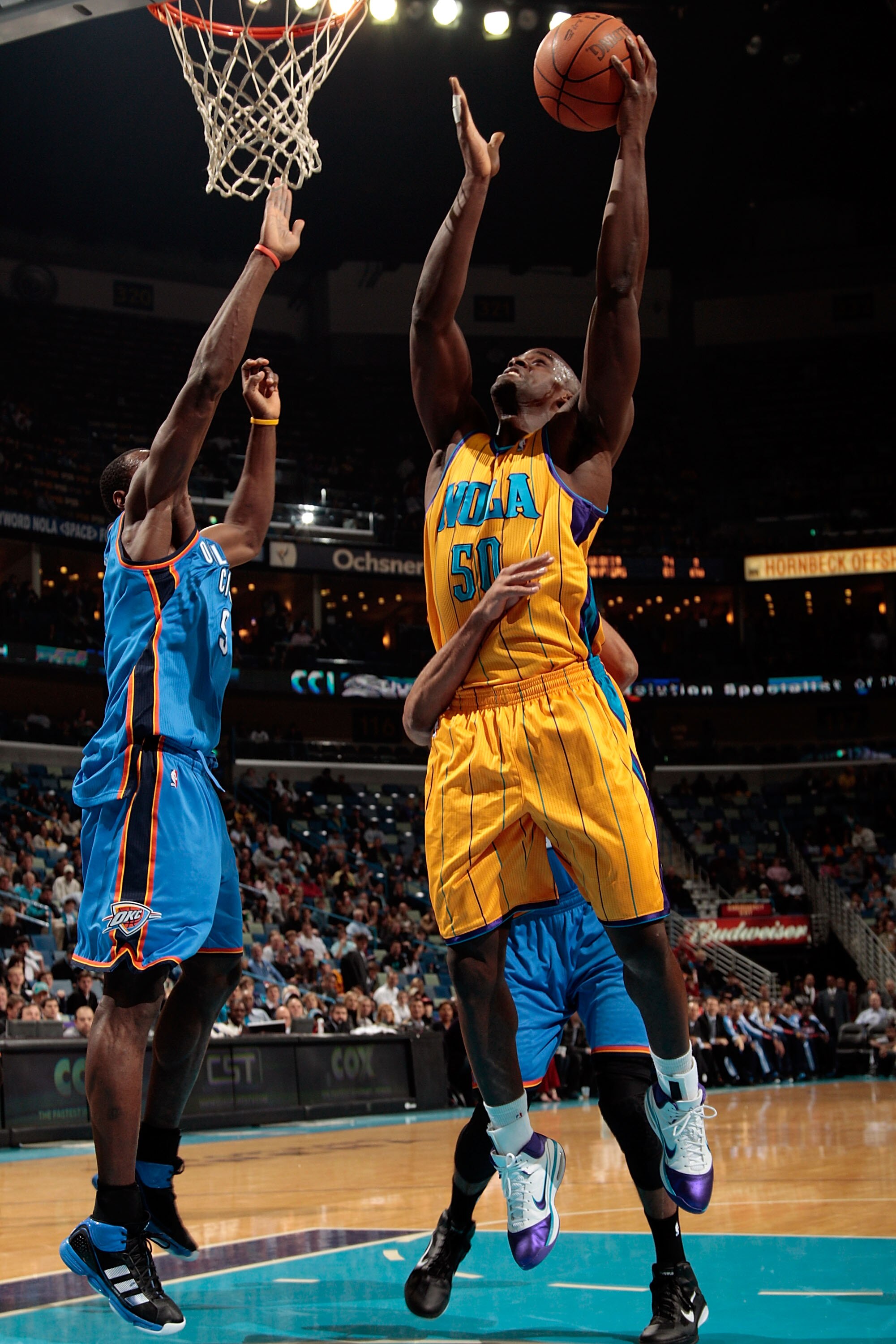 NEW ORLEANS, LA - DECEMBER 10:  Emeka Okafor #50 of the New Orleans Hornets shoots the ball over Serge Ibaka #9 of the Oklahoma City Thunder at New Orleans Arena on December 10, 2010 in New Orleans, Louisiana.    NOTE TO USER: User expressly acknowledges