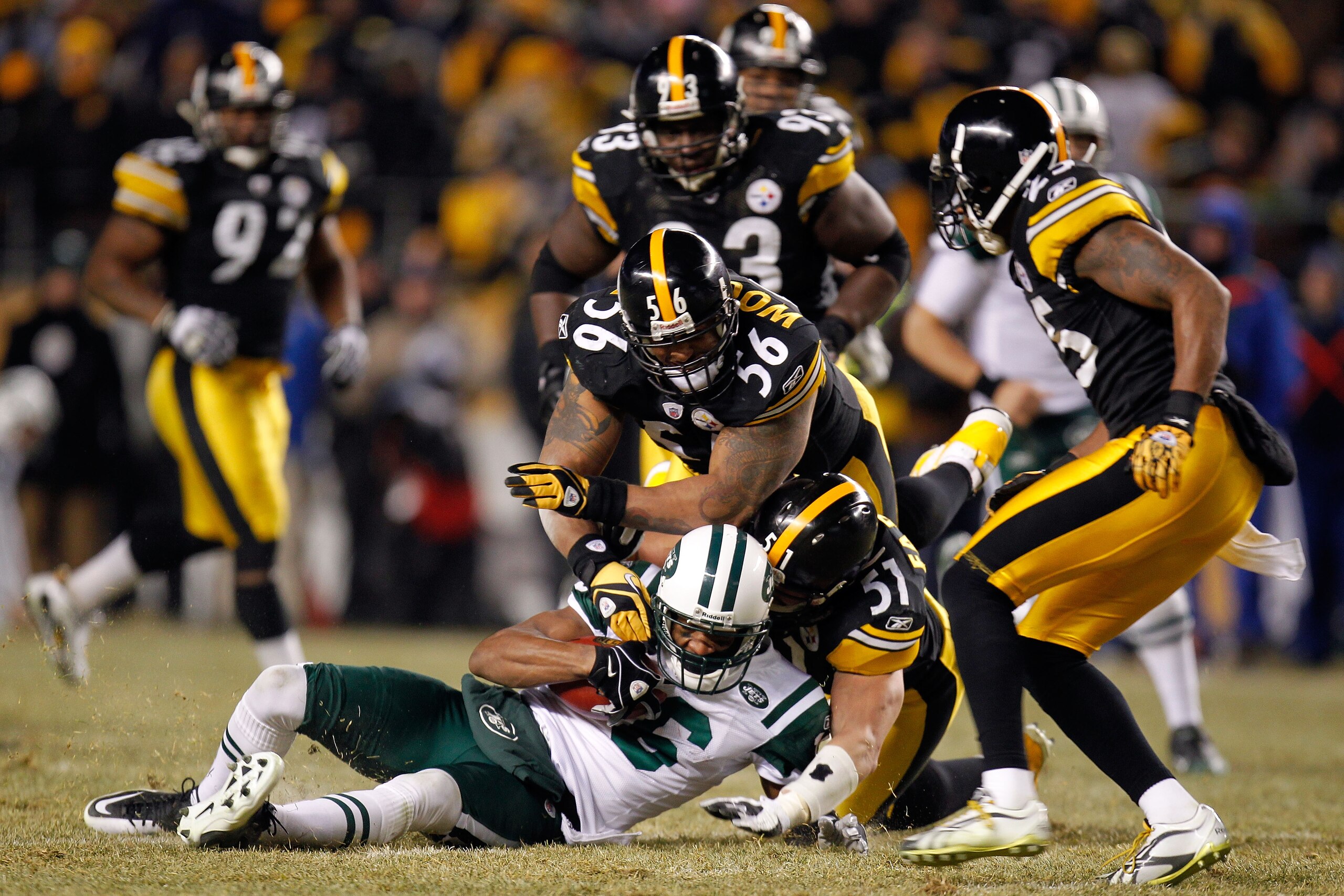 PITTSBURGH, PA - JANUARY 23:  Jeff Cumberland #86 of the New York Jets is tackled by James Farrior #51 and LaMarr Woodley #56 of the Pittsburgh Steelers during the 2011 AFC Championship game at Heinz Field on January 23, 2011 in Pittsburgh, Pennsylvania.