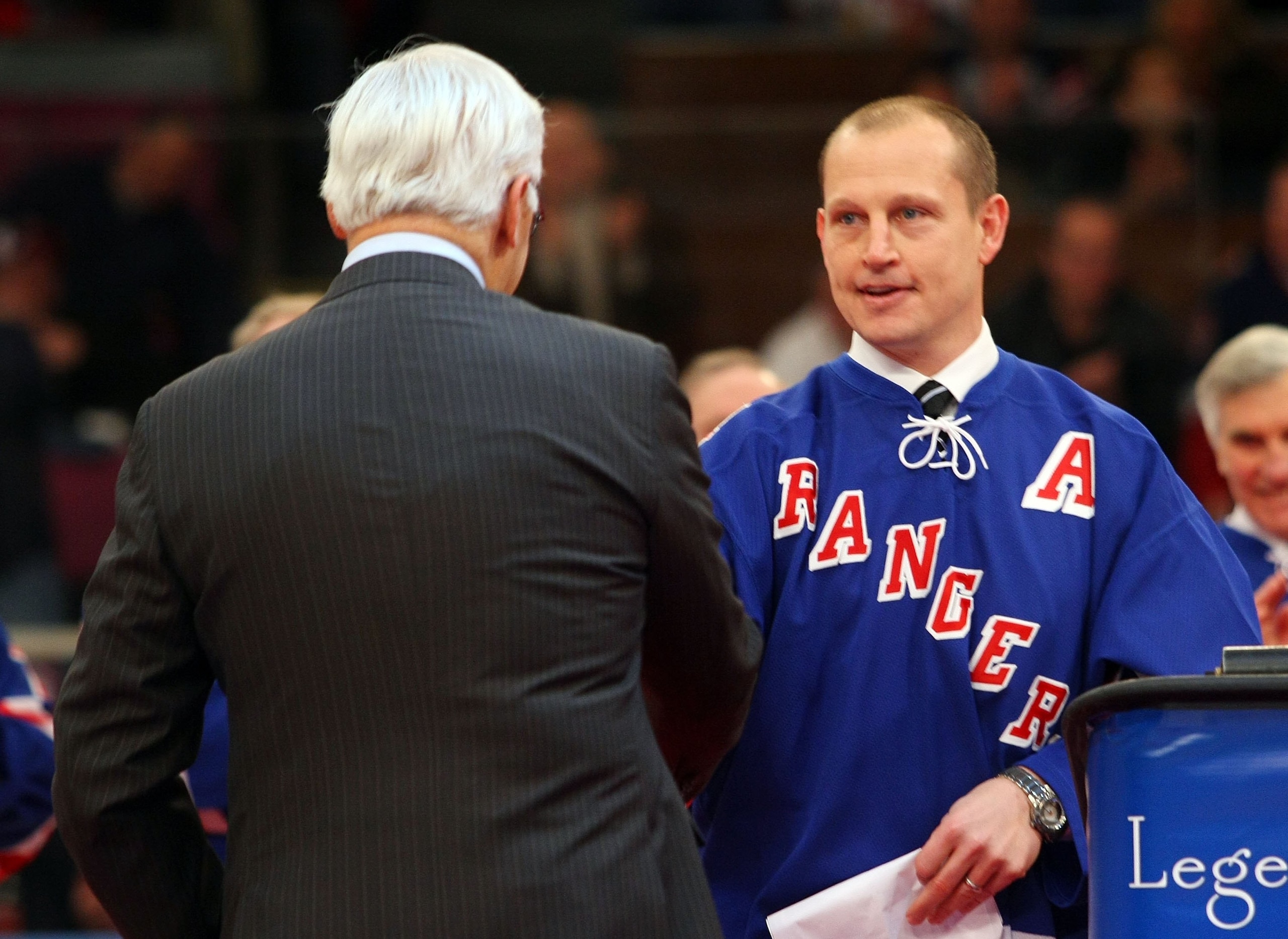 NEW YORK - FEBRUARY 22:  Former New York Ranger players Andy Bathgate and Adam Graves shake hands during a ceremony prior to the game between the Toronto Maple Leafs and the New York Rangers on February 22, 2009 at Madison Square Garden in New York City.
