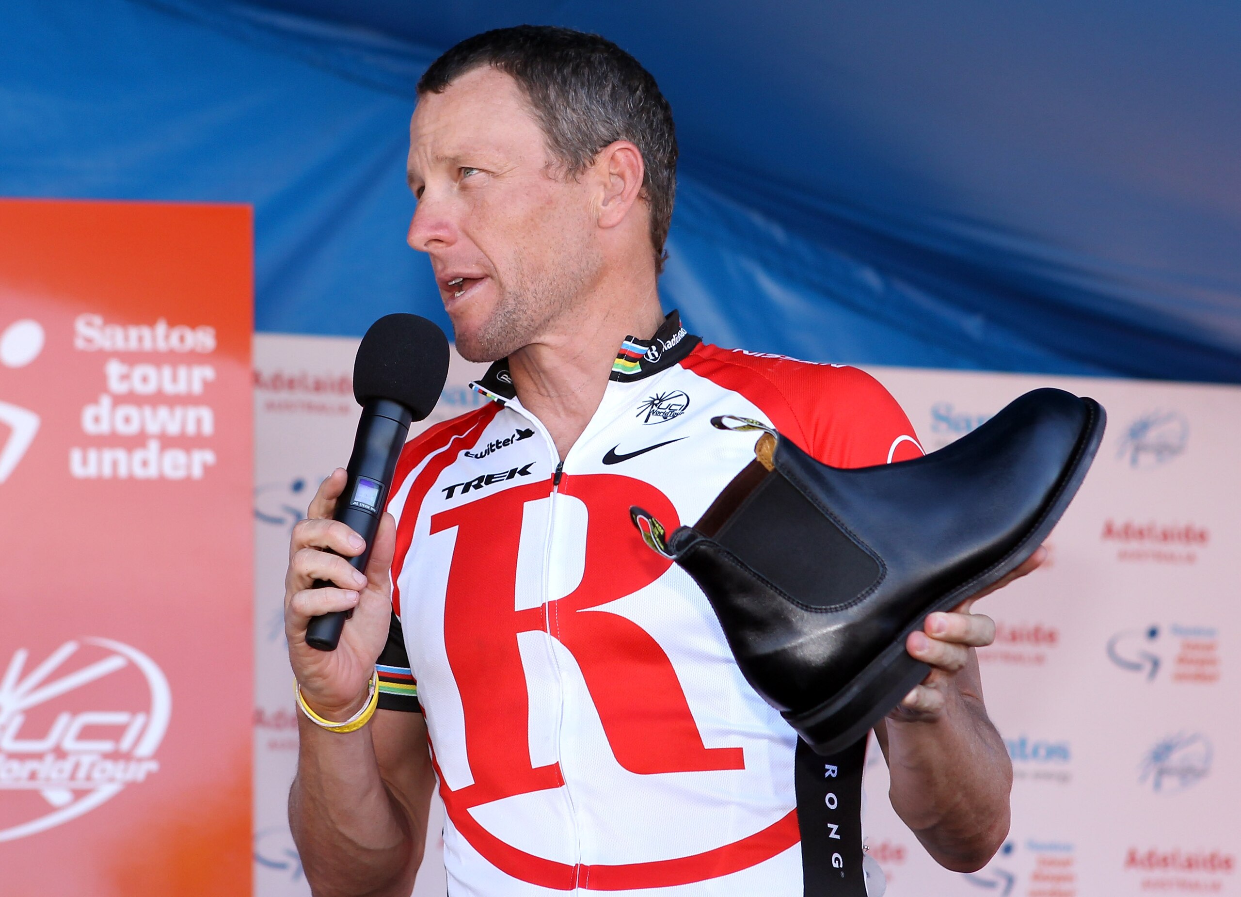 ADELAIDE, AUSTRALIA - JANUARY 23:  Lance Armstrong of the USA and Team Radio Shack holds a RM Williams shoe that is made locally in South Australia and was a presented to him as a gift by the Premier of South Australia, Mike Rann, after Stage Six of the 2