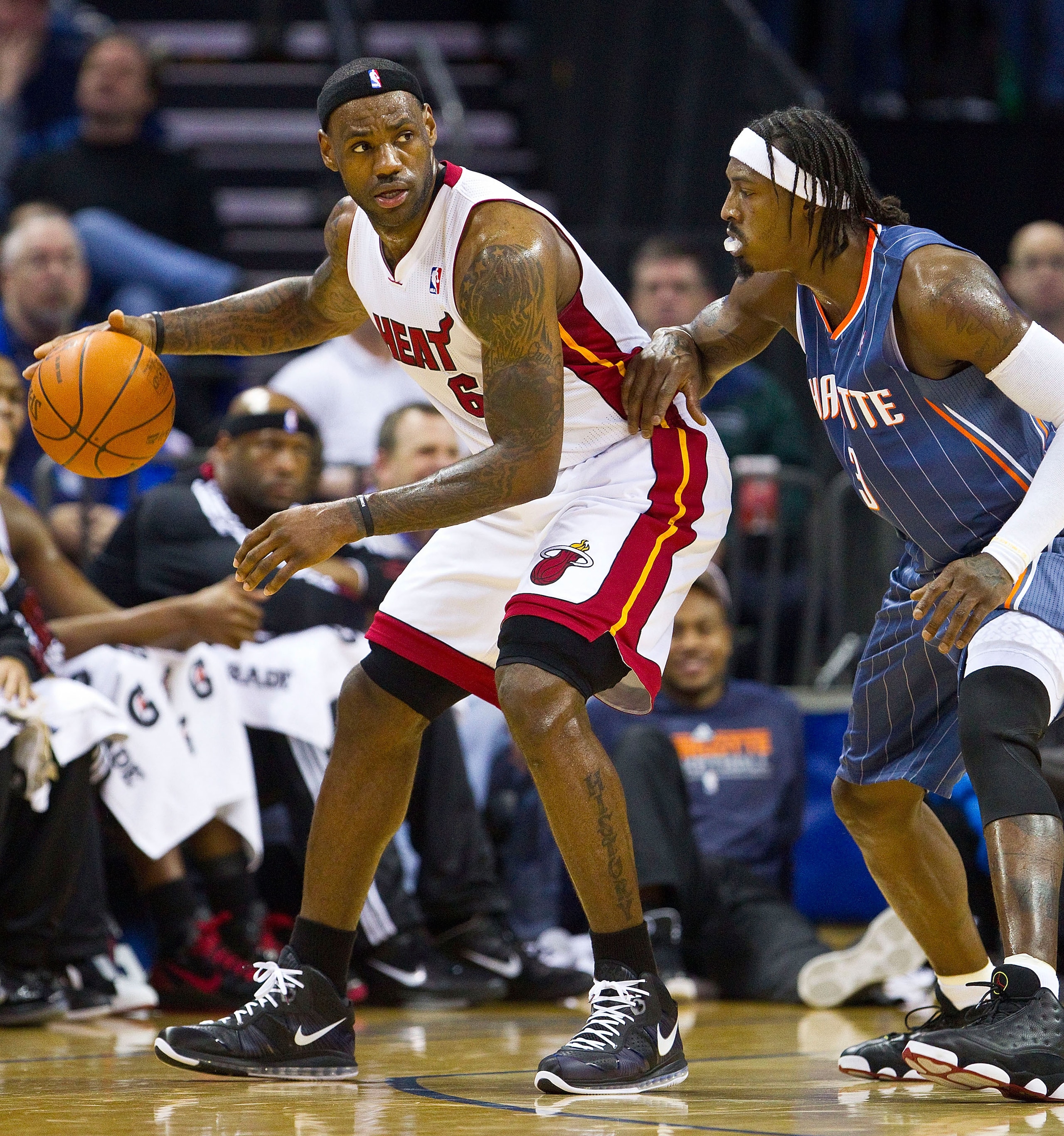 CHARLOTTE, NC - FEBRUARY 04:  LeBron James #6 of the Miami Heat backs down Gerald Wallace #3 of the Charlotte Bobcats at the Time Warner Cable Arena on February 4, 2011 in Charlotte, North Carolina.  The Heat defeated the Bobcats 109-97. NOTE TO USER: Use