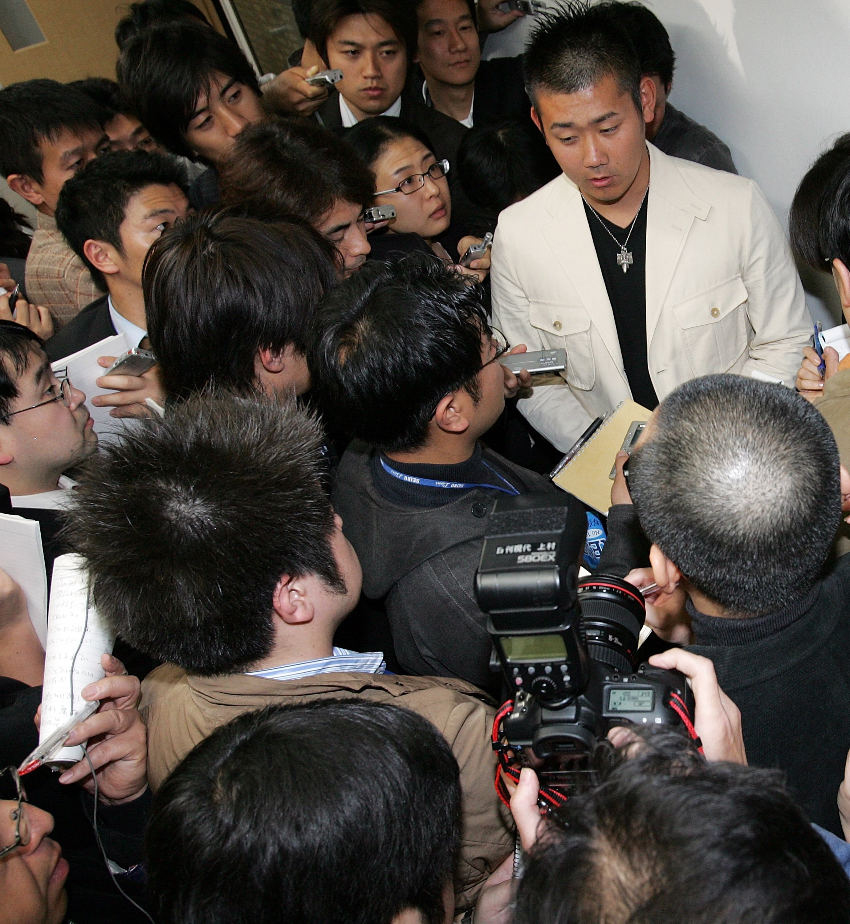 NARITA, JAPAN - NOVEMBER 15: Japanese pitcher Daisuke Matsuzaka arrives at the New Tokyo International Airport on his way to Los Angels on November 15, 2006 in Narita, Chiba Prefecture, Japan. His team Seibu Lions has accepted a bid offered by Boston Red 