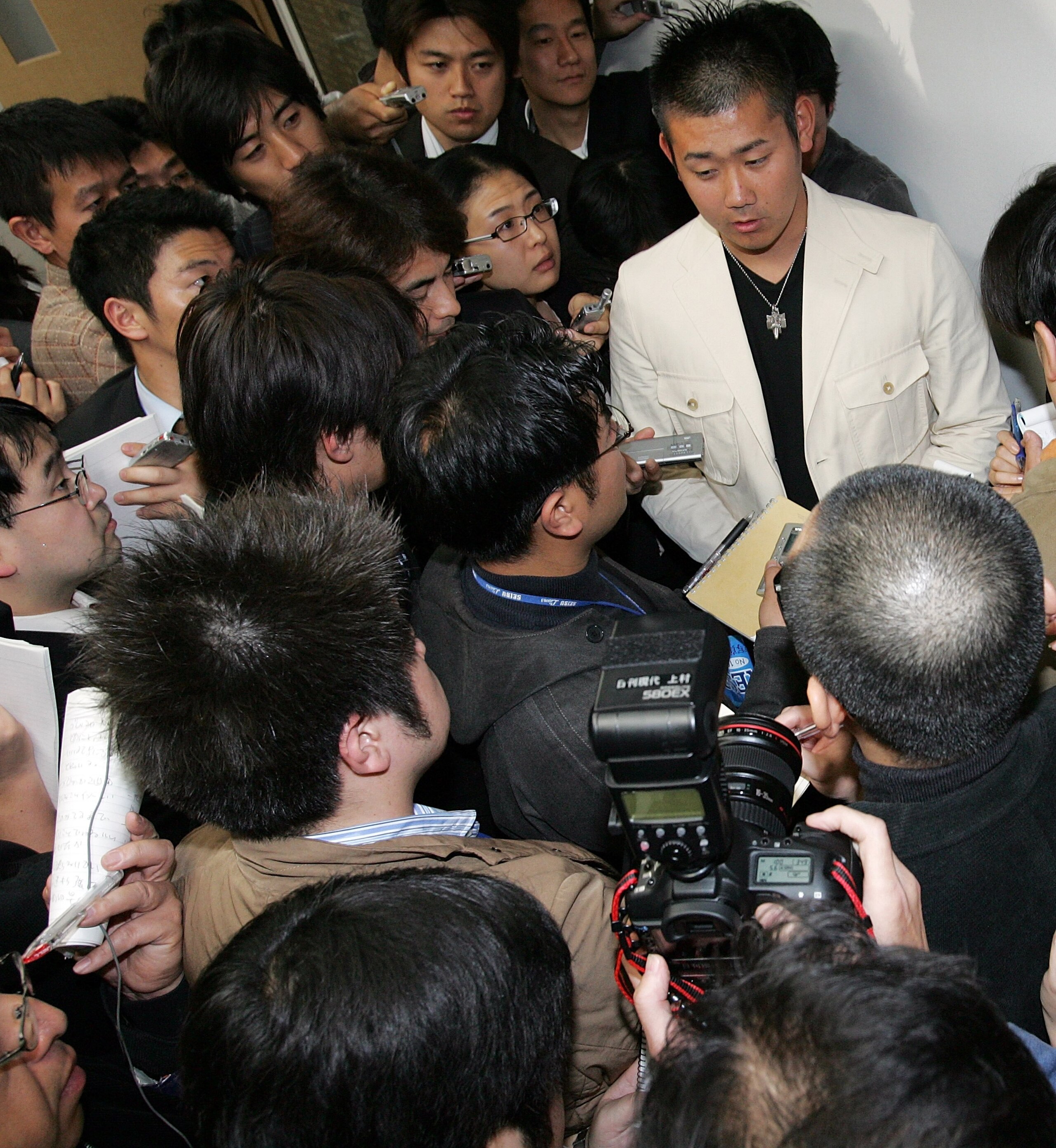NARITA, JAPAN - NOVEMBER 15: Japanese pitcher Daisuke Matsuzaka arrives at the New Tokyo International Airport on his way to Los Angels on November 15, 2006 in Narita, Chiba Prefecture, Japan. His team Seibu Lions has accepted a bid offered by Boston Red 