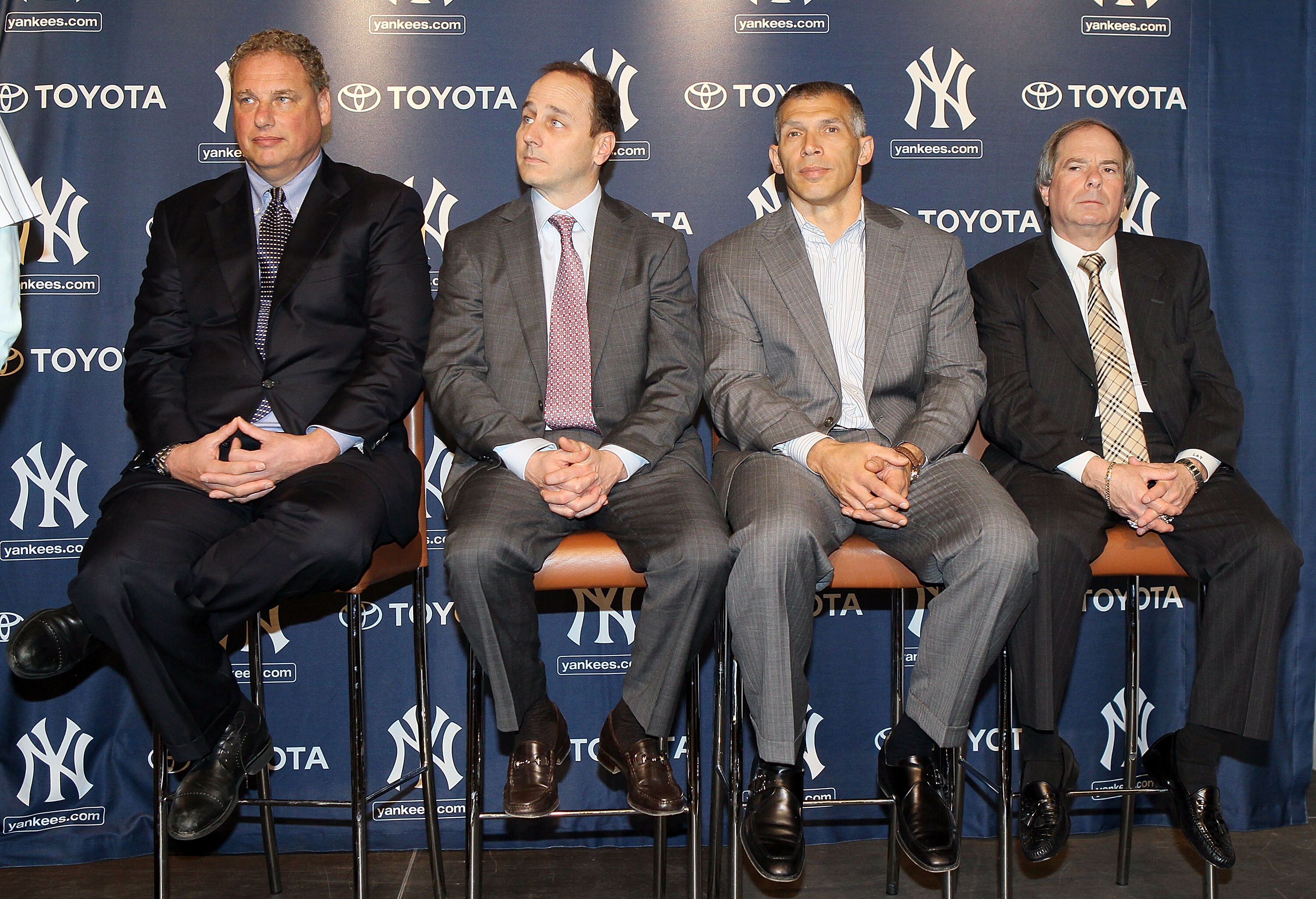 NEW YORK, NY - JANUARY 19:  (L-R) President Randy Levine, general manager Brian Cashman, manager Joe Girardi and COO Lonn Trost of the New York Yankees listen as Rafael Soriano (not pictured) speaks during his introduction press conference on January 19,