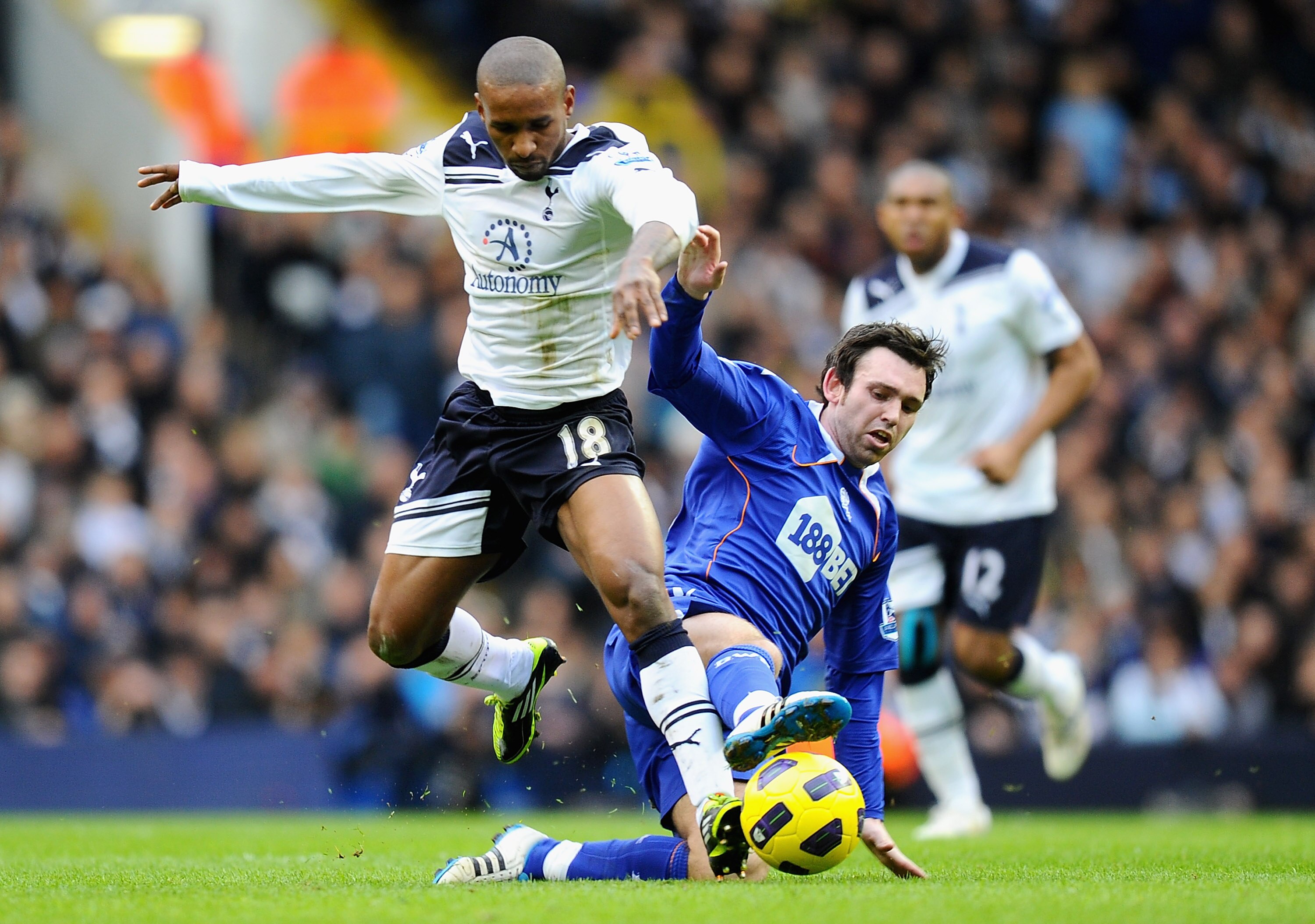 LONDON, ENGLAND - FEBRUARY 05:  Mark Davies of Bolton Wanderers tackles Jermain Defoe of Tottenham Hotspur during the Barclays Premier League match between Tottenham Hotspur and Bolton Wanderers at White Hart Lane on February 5, 2011 in London, England.