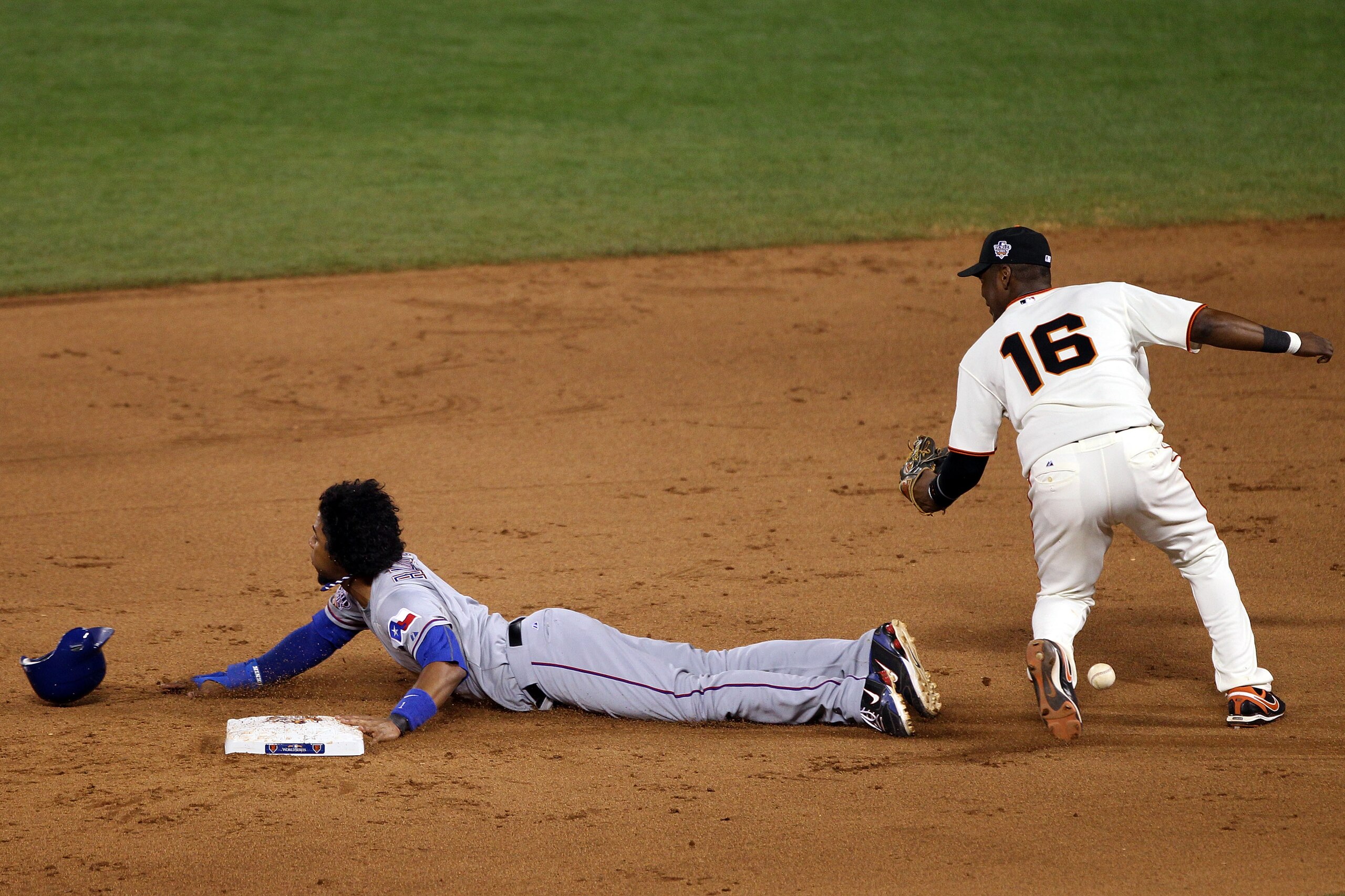 SAN FRANCISCO - OCTOBER 28:  Elvis Andrus #1 of the Texas Rangers steals second base as the ball gets away from Edgar Renteria #16 of the San Francisco Giants in the eighth inning of Game Two of the 2010 MLB World Series at AT&T Park on October 28, 2010 i