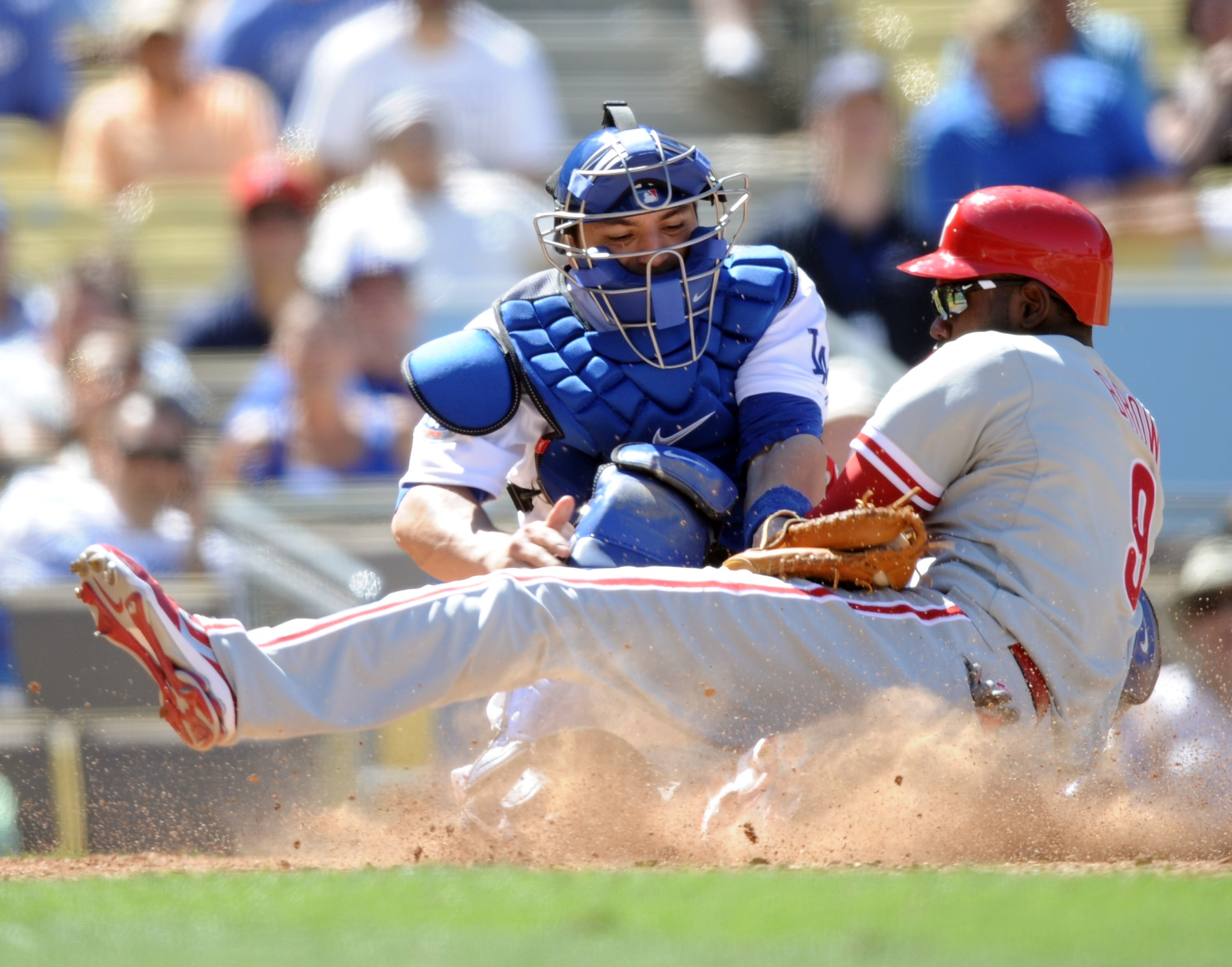 LOS ANGELES, CA - SEPTEMBER 01:  Domonic Brown #9 of the Philadelphia Phillies slides safely under the tag of Rod Barajas #28 of the Los Angeles Dodgers for a 5-1 lead during the ninth inning at Dodger Stadium on September 1, 2010 in Los Angeles, Californ