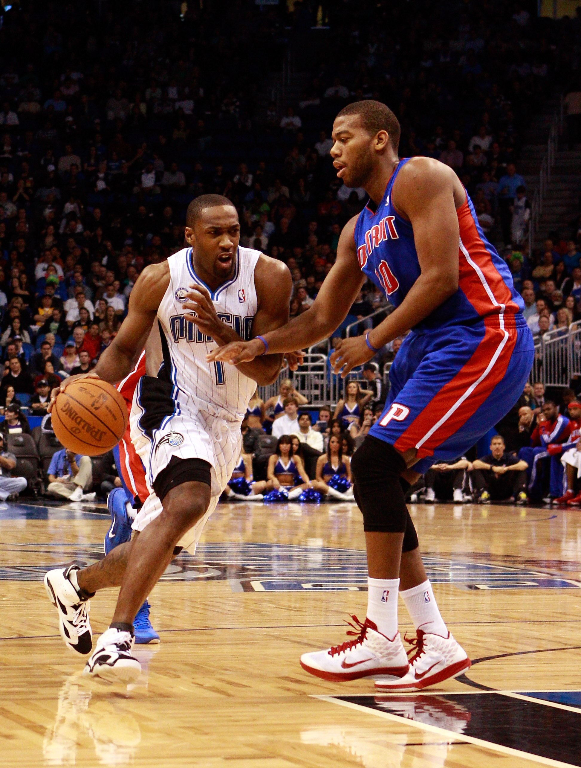 ORLANDO, FL - JANUARY 24:  Gilbert Arenas #1 of the Orlando Magic drives against Greg Monroe #10 of the Detroit Pistons during the game at Amway Arena on January 24, 2011 in Orlando, Florida.  NOTE TO USER: User expressly acknowledges and agrees that, by