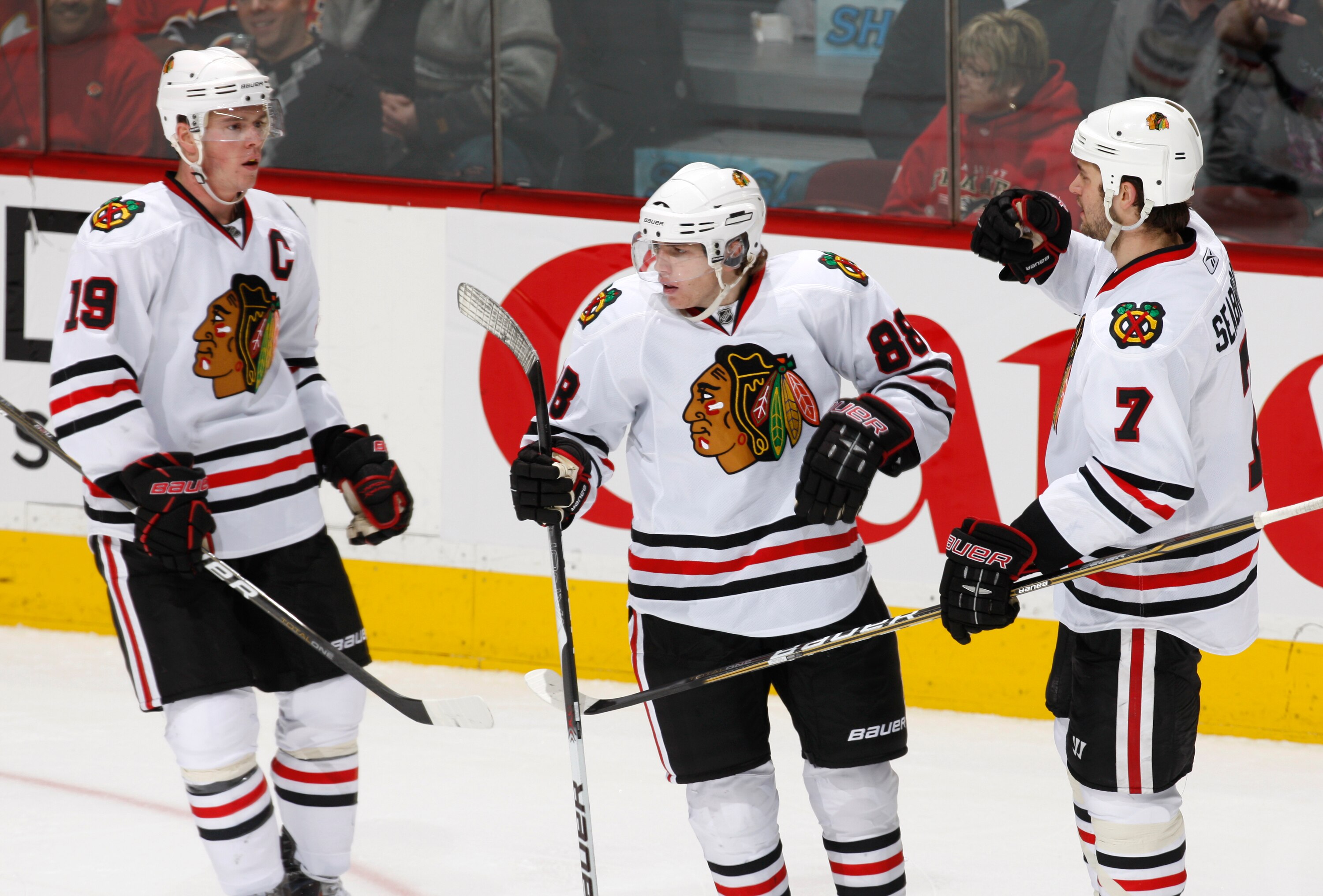 CALGARY, CANADA - FEBRUARY 7: Patrick Kane #88 of the Chicago Black Hawks celebrates with Jonathon Toews #19 and Brent Seakbrooke #7 in second period action against the Calgary Flames at Scotiabank Saddledome February 7, 2011 in Calgary, Alberta, Canada.