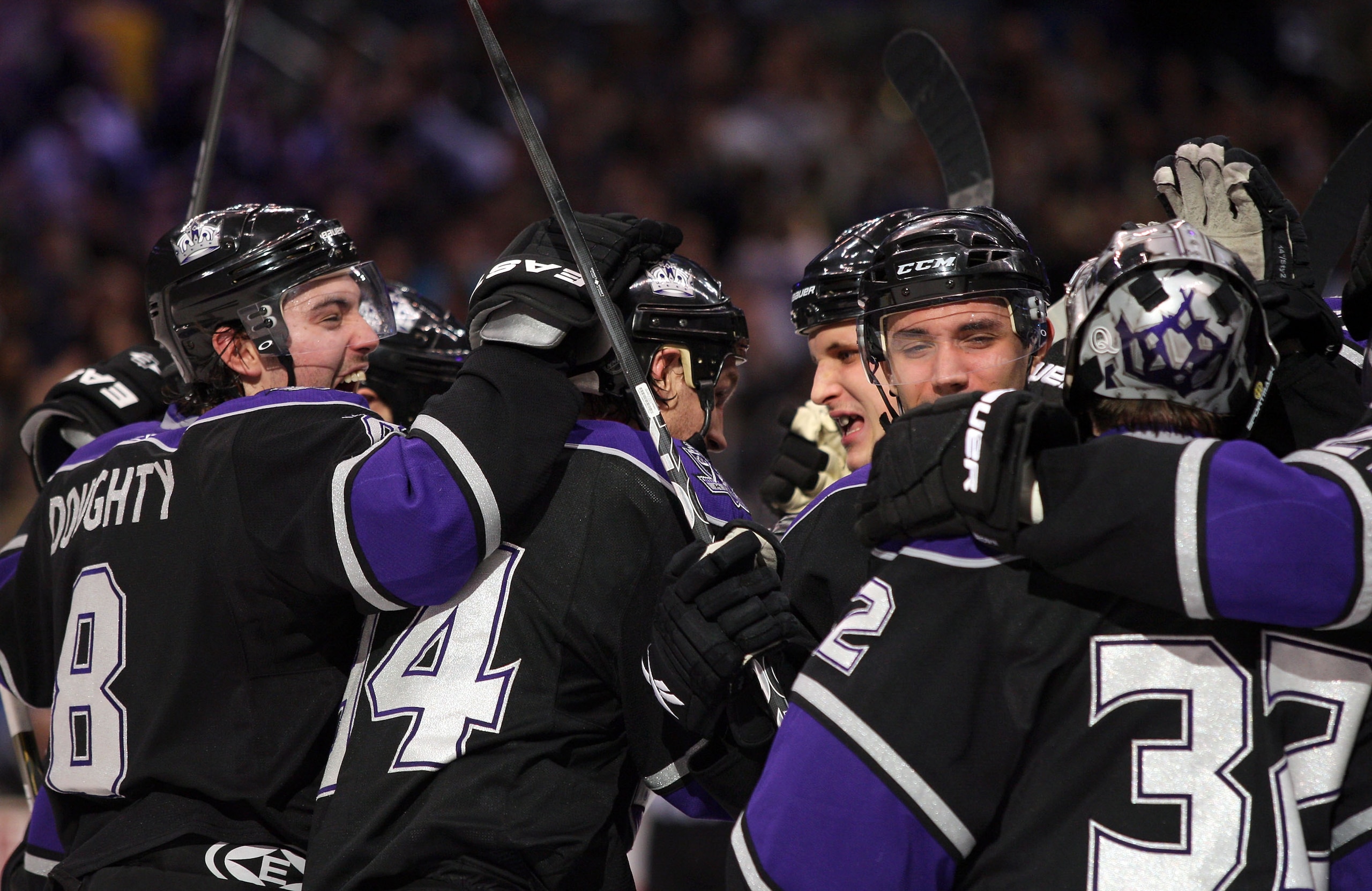 LOS ANGELES, CA - JANUARY 26:  (L-R)Drew Doughty #8, Ryan Smyth #94, Kyle Clifford #13 and Alec Martinez #53 and goaltender Jonathan Quick #32 of the Los Angeles Kings celebrate after defeating the San Jose Sharks 3-2 in shootout overtime at Staples Cente