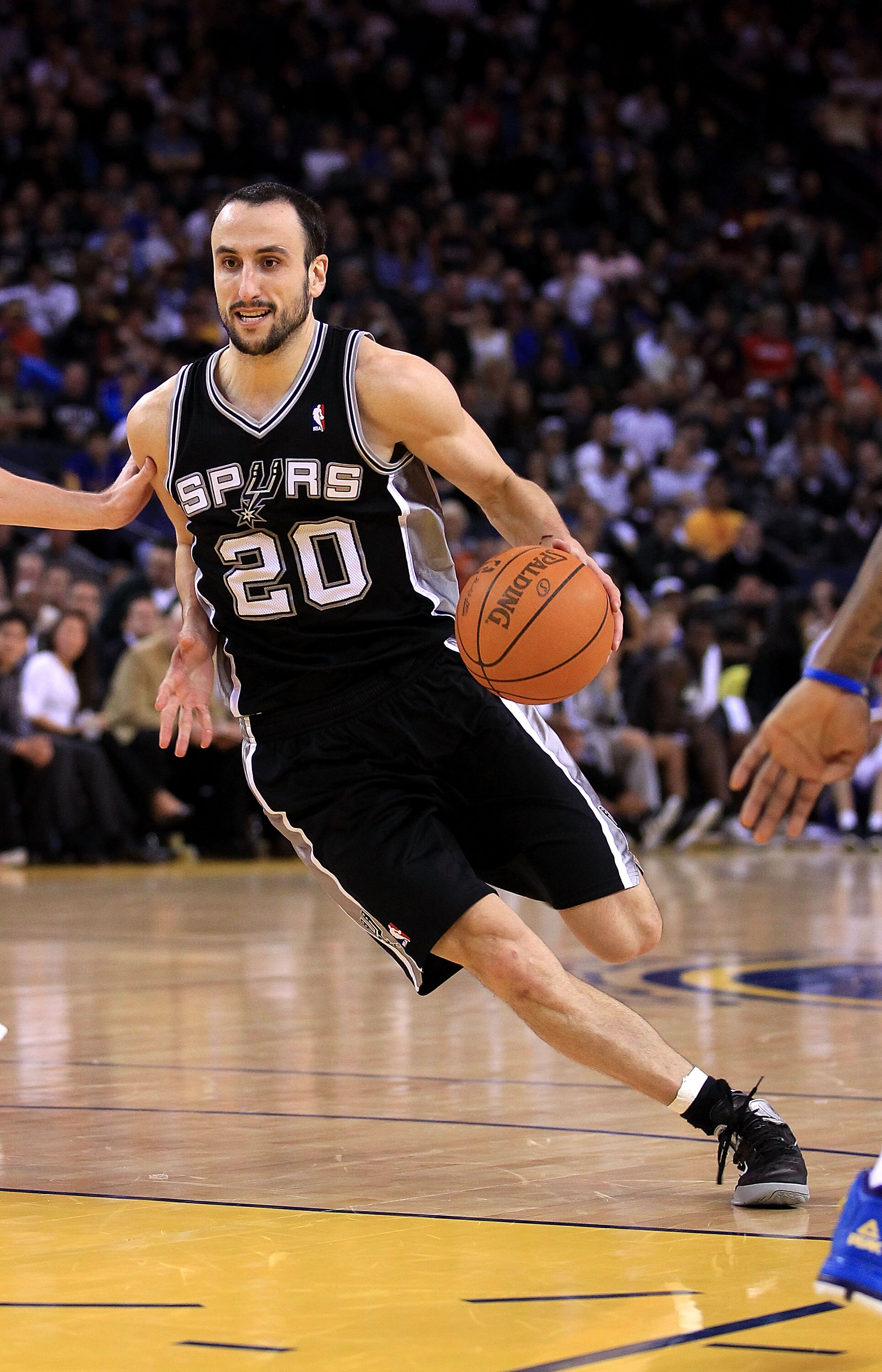OAKLAND, CA - JANUARY 24:  Manu Ginobili #20 of the San Antonio Spurs in action against the Golden State Warriors at Oracle Arena on January 24, 2011 in Oakland, California.  NOTE TO USER: User expressly acknowledges and agrees that, by downloading and or