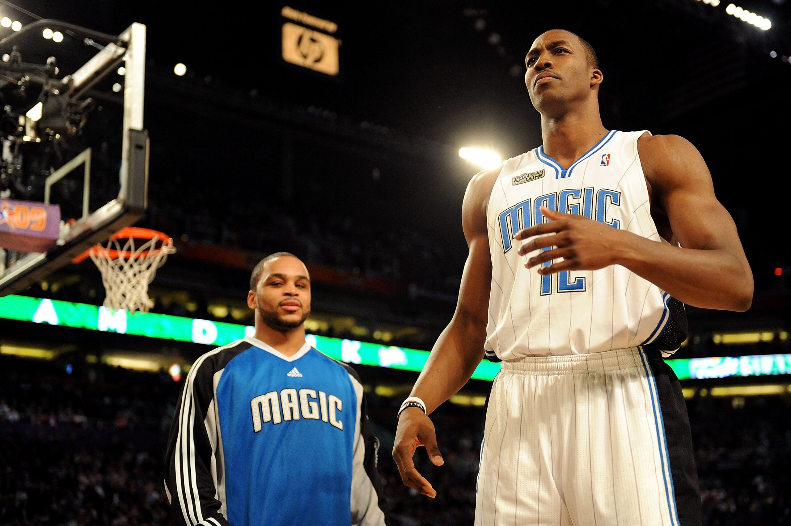 PHOENIX - FEBRUARY 14:  Jameer Nelson helps out teammate Dwight Howard of the Orlando Magic in the Sprite Slam Dunk Contest on All-Star Saturday Night, part of 2009 NBA All-Star Weekend at US Airways Center on February 14, 2009 in Phoenix, Arizona.  NOTE