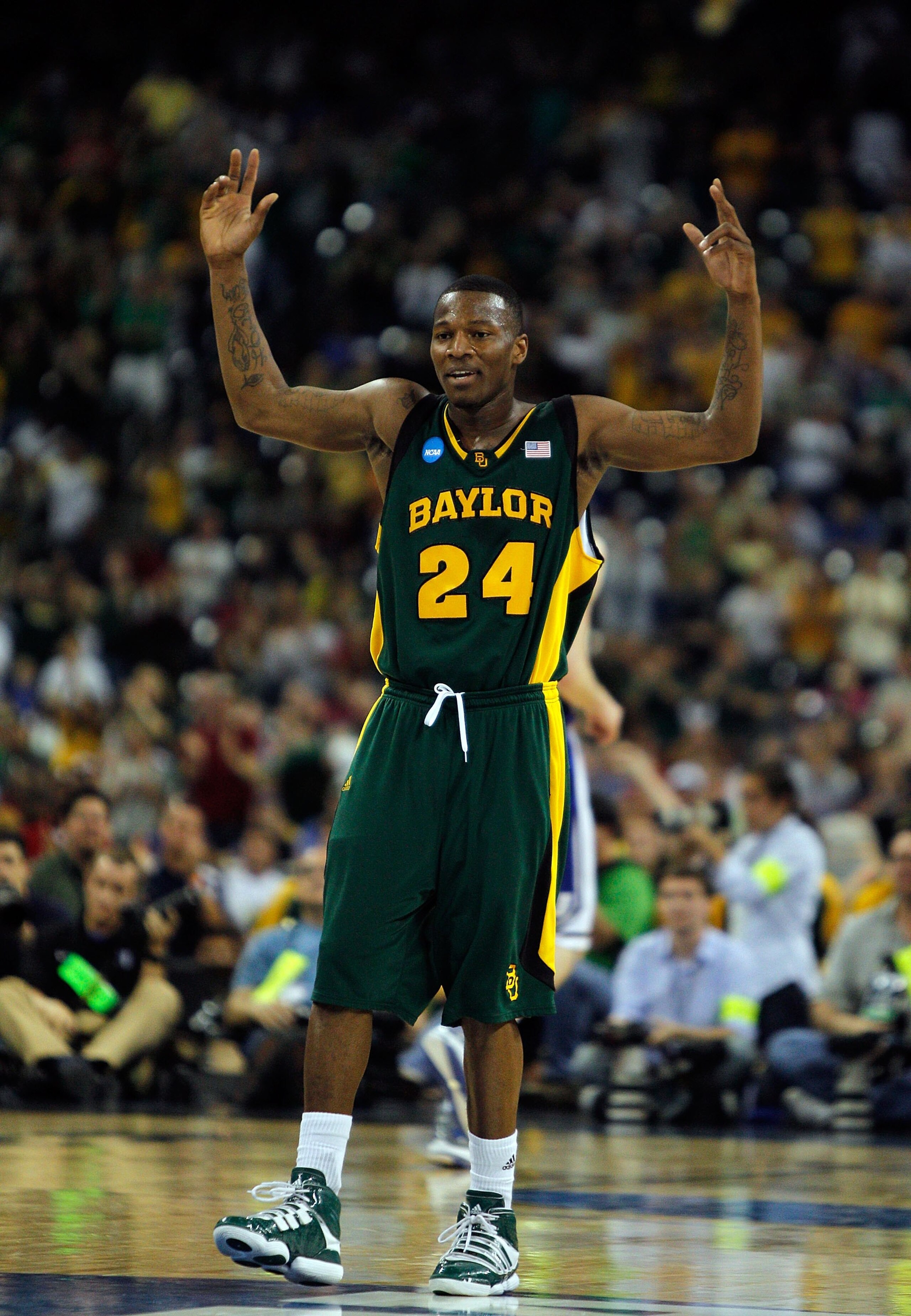 HOUSTON - MARCH 28: LaceDarius Dunn #24 of the Baylor Bears encourages the crowd against the Duke Blue Devils during the south regional final of the 2010 NCAA men's basketball tournament at Reliant Stadium on March 28, 2010 in Houston, Texas. Duke defeate
