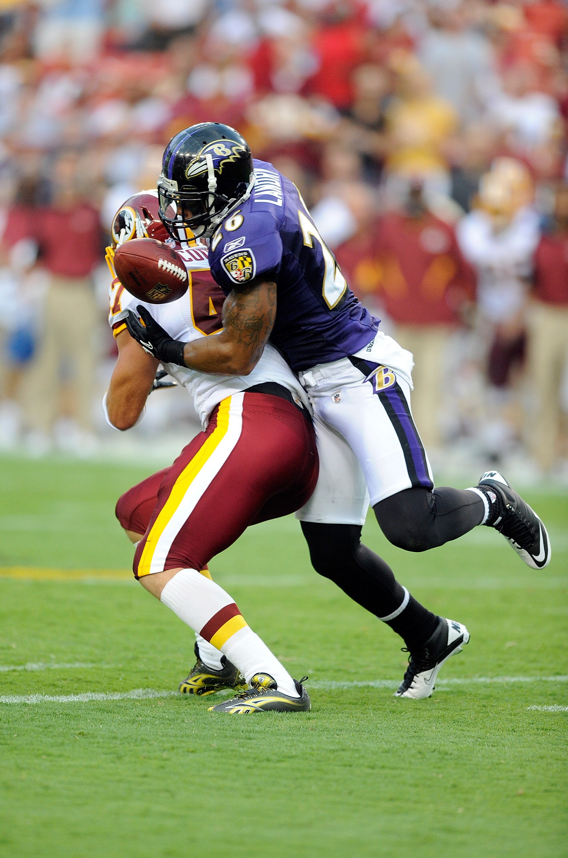 LANDOVER, MD - AUGUST 21:  Dawan Landry #26 of the Baltimore Ravens breaks up a pass during the preseason game intended for Chris Cooley #47 of the Washington Redskins at FedExField on August 21, 2010 in Landover, Maryland.  (Photo by Greg Fiume/Getty Ima