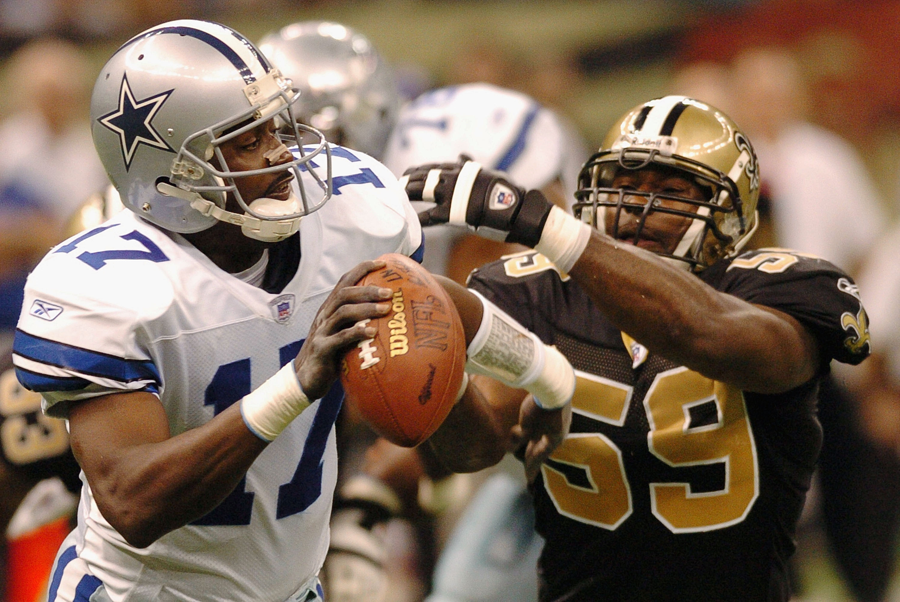 NEW ORLEANS - DECEMBER 28:  Quincy Carter #17 of the Dallas Cowboys escapes a sack from Derrick Rodgers #59 of the New Orleans Saints December 28, 2003 at the Superdome in New Orleans, Louisiana.  (Photo by Chris Graythen/Getty Images)
