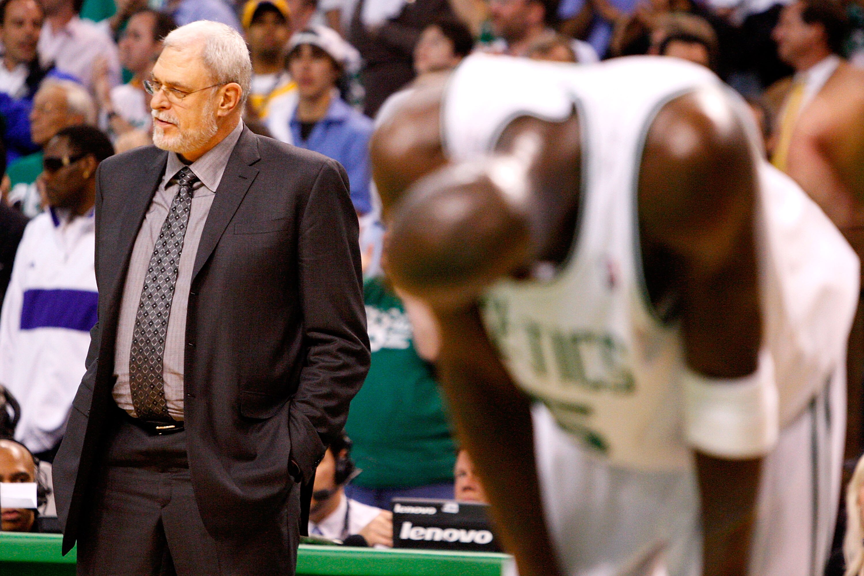 BOSTON - JUNE 05:  Head coach Phil Jackson of the Los Angeles Lakers stands on the sideline as Kevin Garnett #5 of the Boston Celtics bends over in the second half of Game One of the 2008 NBA Finals on June 5, 2008 at TD Banknorth Garden in Boston, Massac