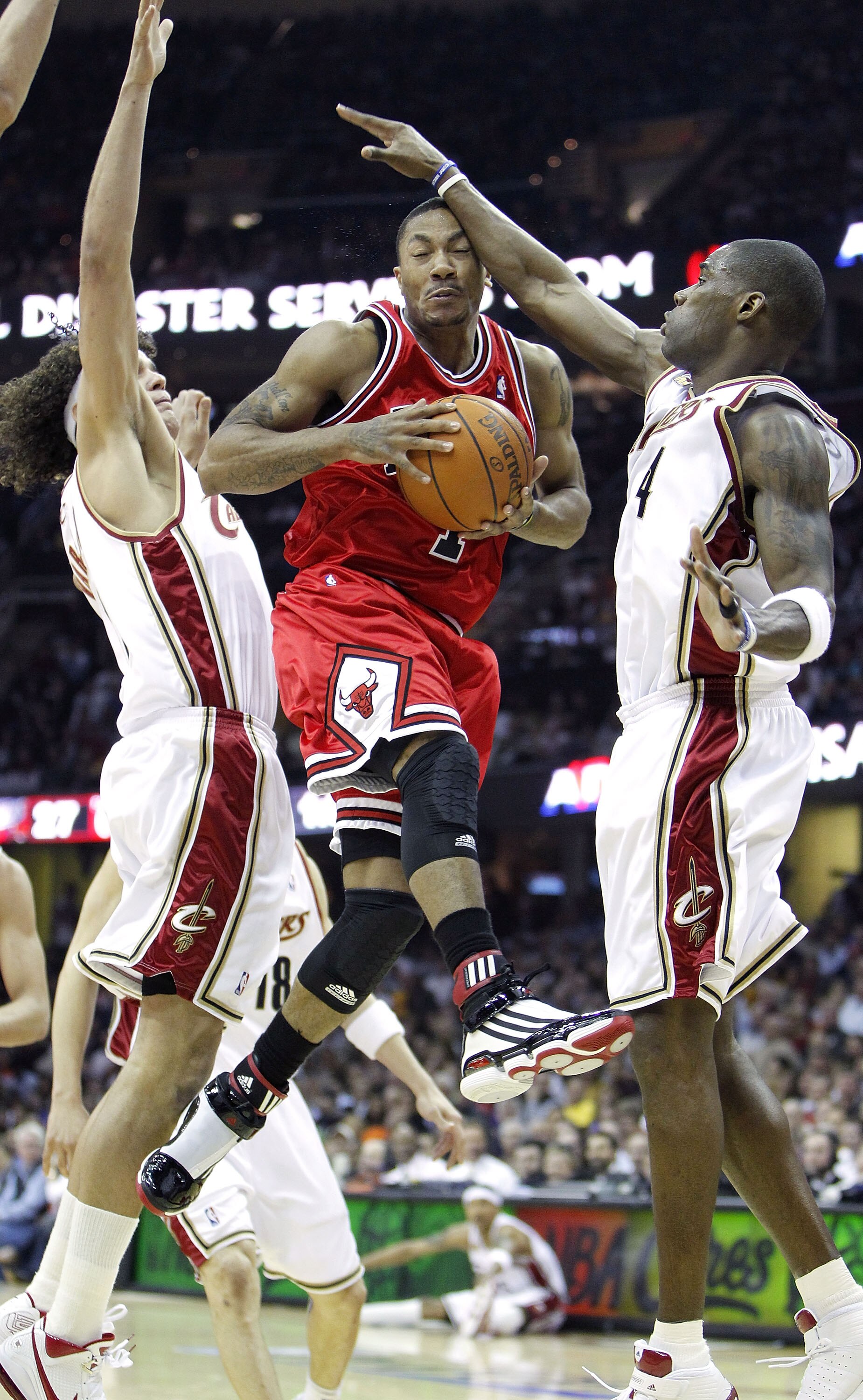 CLEVELAND - APRIL 27: Derrick Rose #1 of the Chicago Bulls goes up for a shot against Antawn Jamison #4 and Anderson Varejao #17 of the Cleveland Cavaliers in Game Five of the Eastern Conference Quarterfinals during the 2010 NBA Playoffs at Quicken Loans 