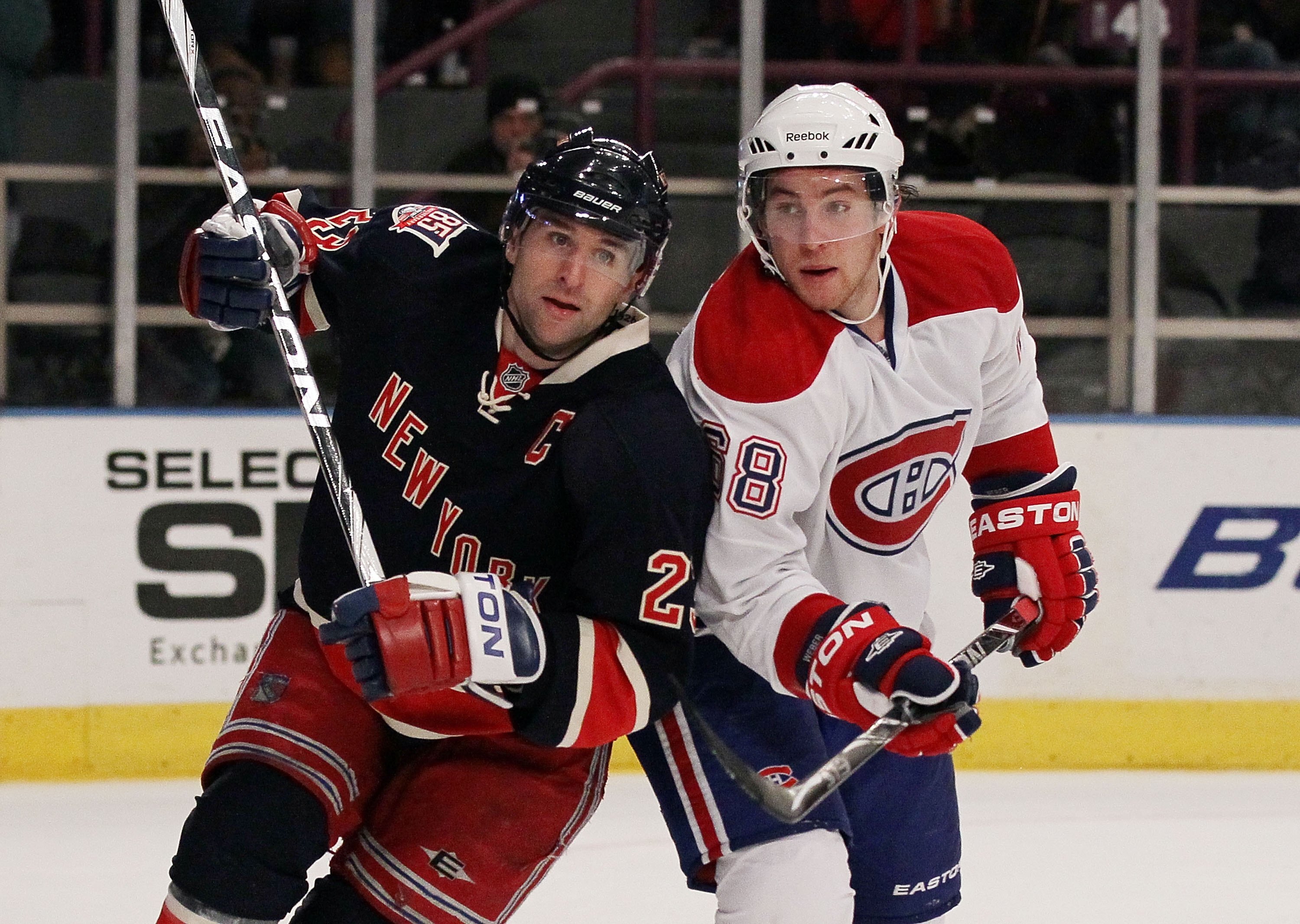 NEW YORK, NY - JANUARY 11:  Chris Drury #23 of the New York Rangers skates against Yannick Weber #68 of the Montreal Canadiens on January 11, 2011 at Madison Square Garden in New York City. Montreal defeated the Rangers 2-1.  (Photo by Jim McIsaac/Getty I