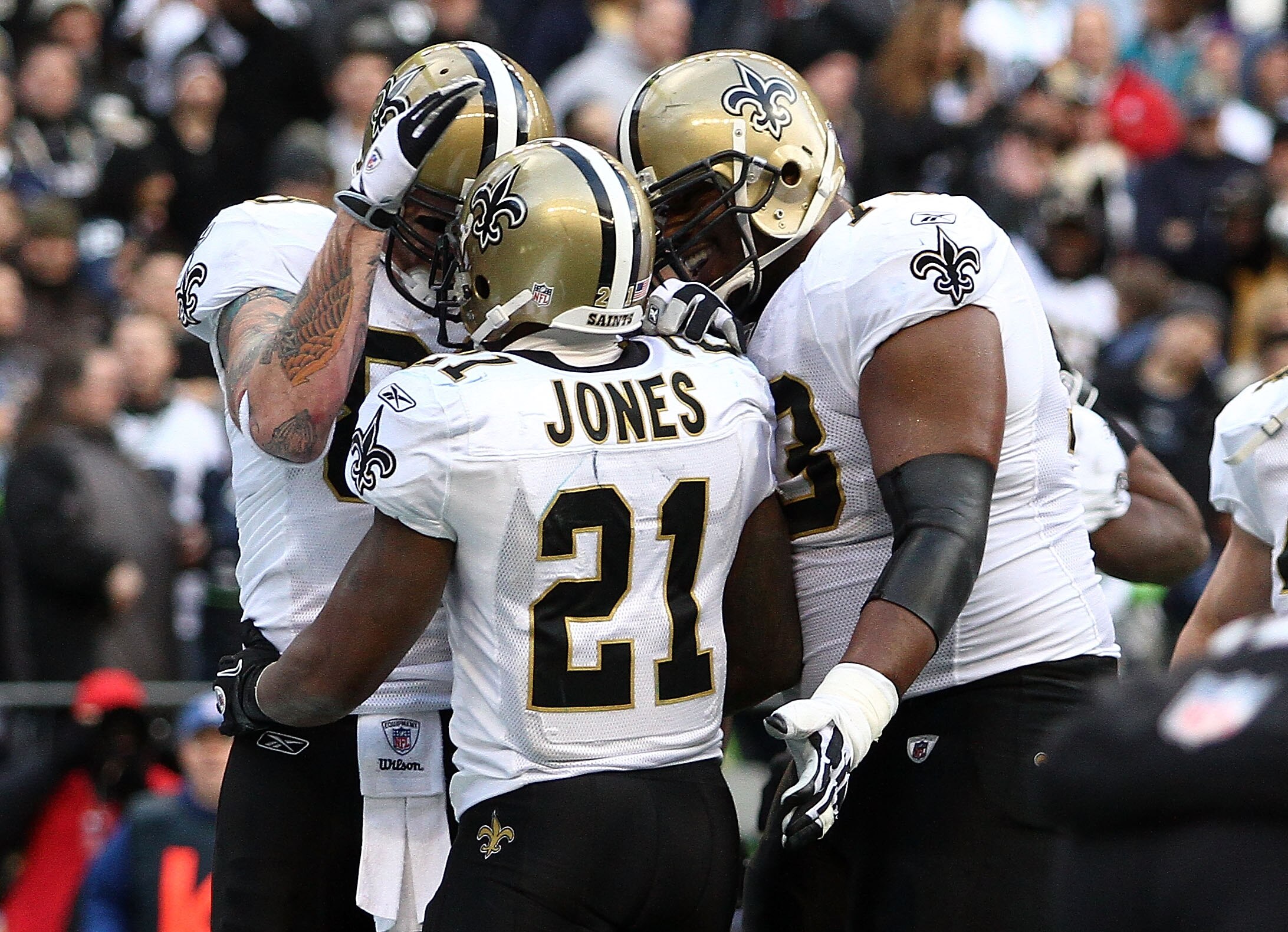 SEATTLE, WA - JANUARY 08:  Julius Jones #21 of the New Orleans Saints celebrates his five-yard touchdown run in the second quarter with teammates against the Seattle Seahawks during the 2011 NFC wild-card playoff game at Qwest Field on January 8, 2011 in
