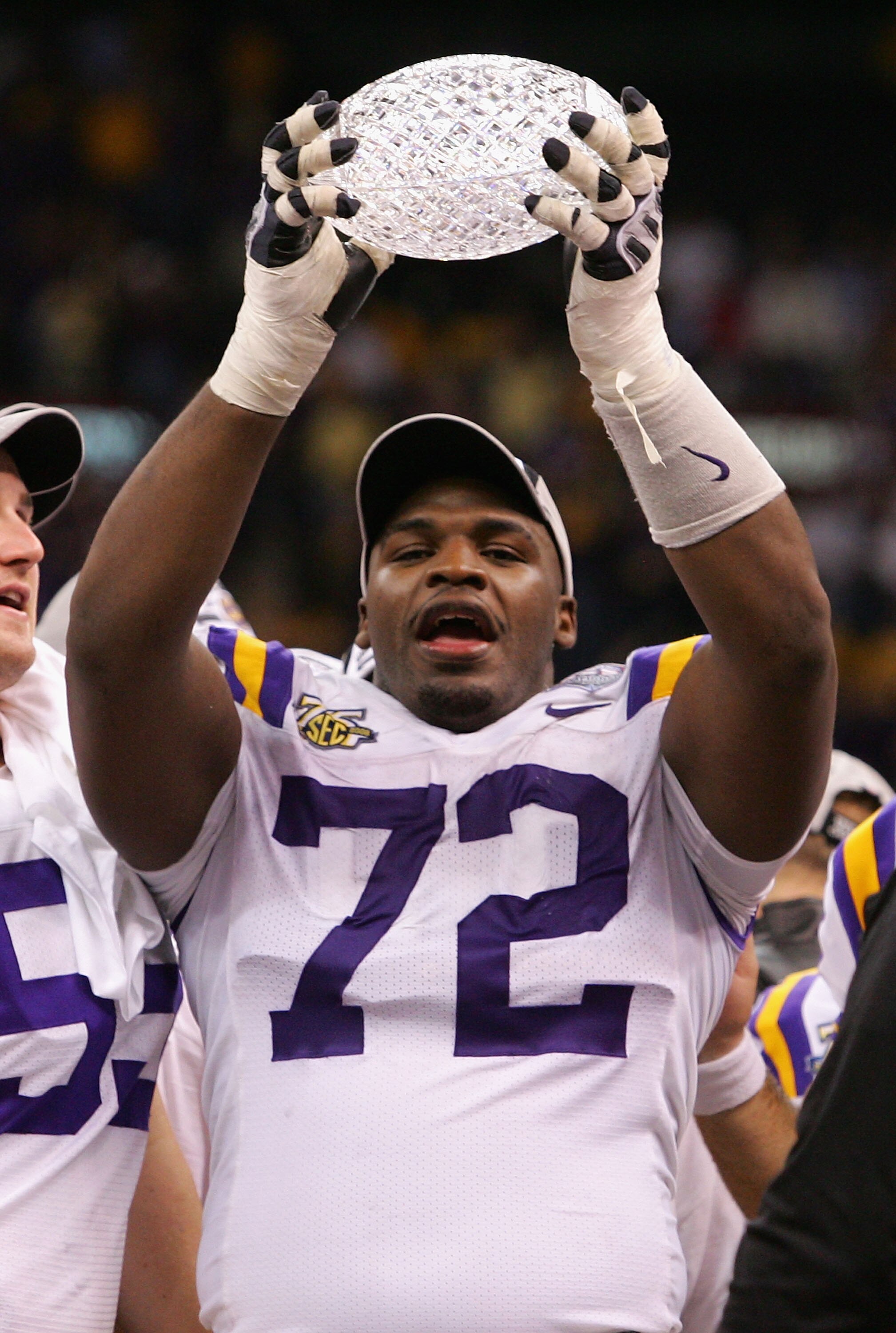 NEW ORLEANS - JANUARY 07: Glenn Dorsey #72 of the Louisiana State University Tigers raises the trophy after defeating the Ohio State Buckeyes 38-24 in the AllState BCS National Championship on January 7, 2008 at the Louisiana Superdome in New Orleans, Lou