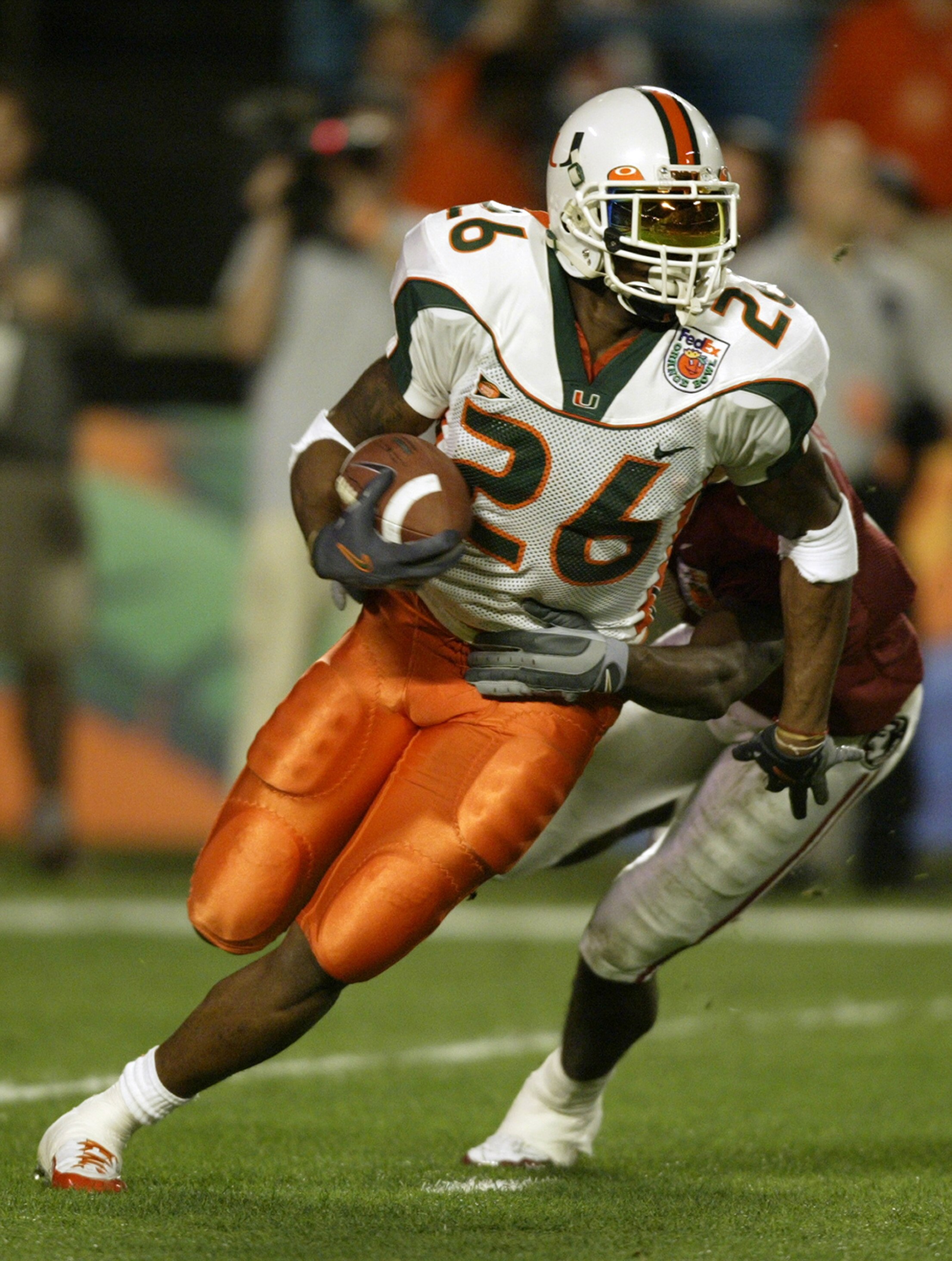 MIAMI - JANUARY 1:  Defensive back Sean Taylor #26 of the Miami Hurricanes attempts to elude wide receiver P.K. Sam #4 of the Florida State Seminoles during the 2004 Orange Bowl game on January 1, 2004 at Pro Player Stadium in Miami, Florida. The Hurrican