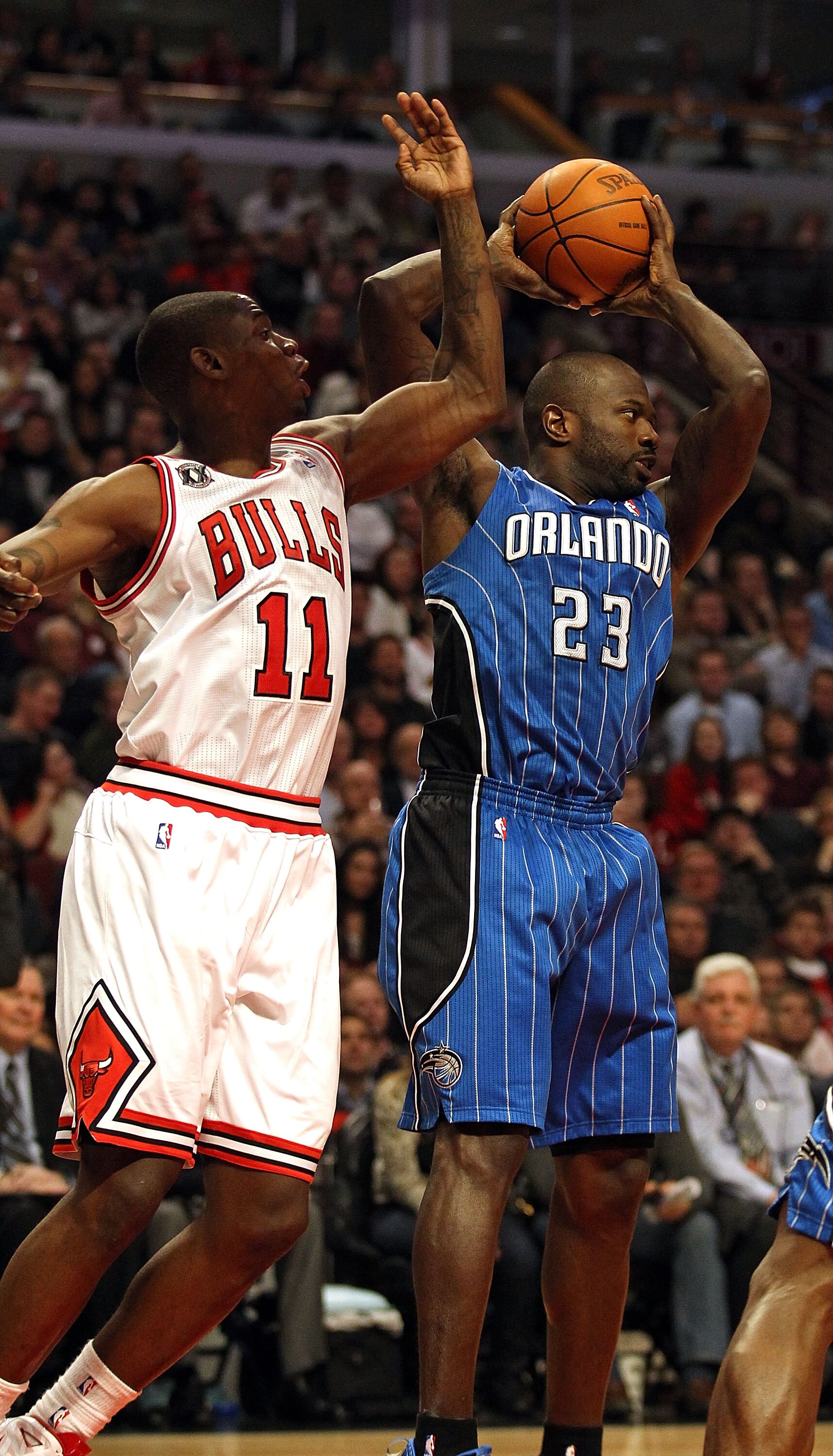CHICAGO, IL - JANUARY 28: Jason Richardson #23 of the Orlando Magic grabs a rebound next to Ronnie Brewer #11 of the Chicago Bulls at the United Center on January 28, 2011 in Chicago, Illinois. The Bulls defeated the Magic 99-90. NOTE TO USER: User expres