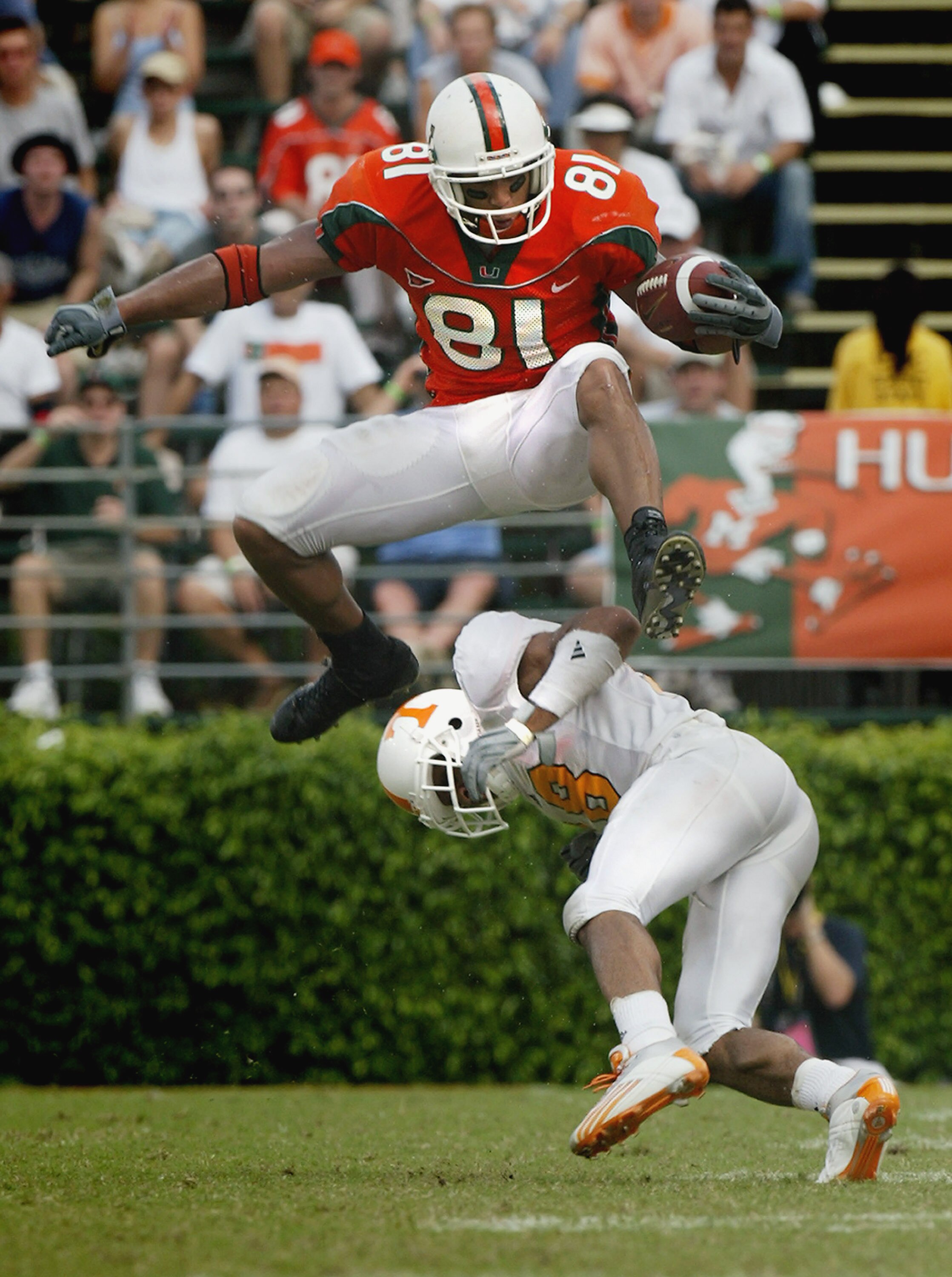 MIAMI - NOVEMBER 8:  Tight end Kellen Winslow #81 of the University of Miami Hurricanes jumps over defensive back Jason Allen #18 of the University of Tennessee Volunteers during the game at the Orange Bowl on November 8, 2003 in Miami, Florida. Tennessee