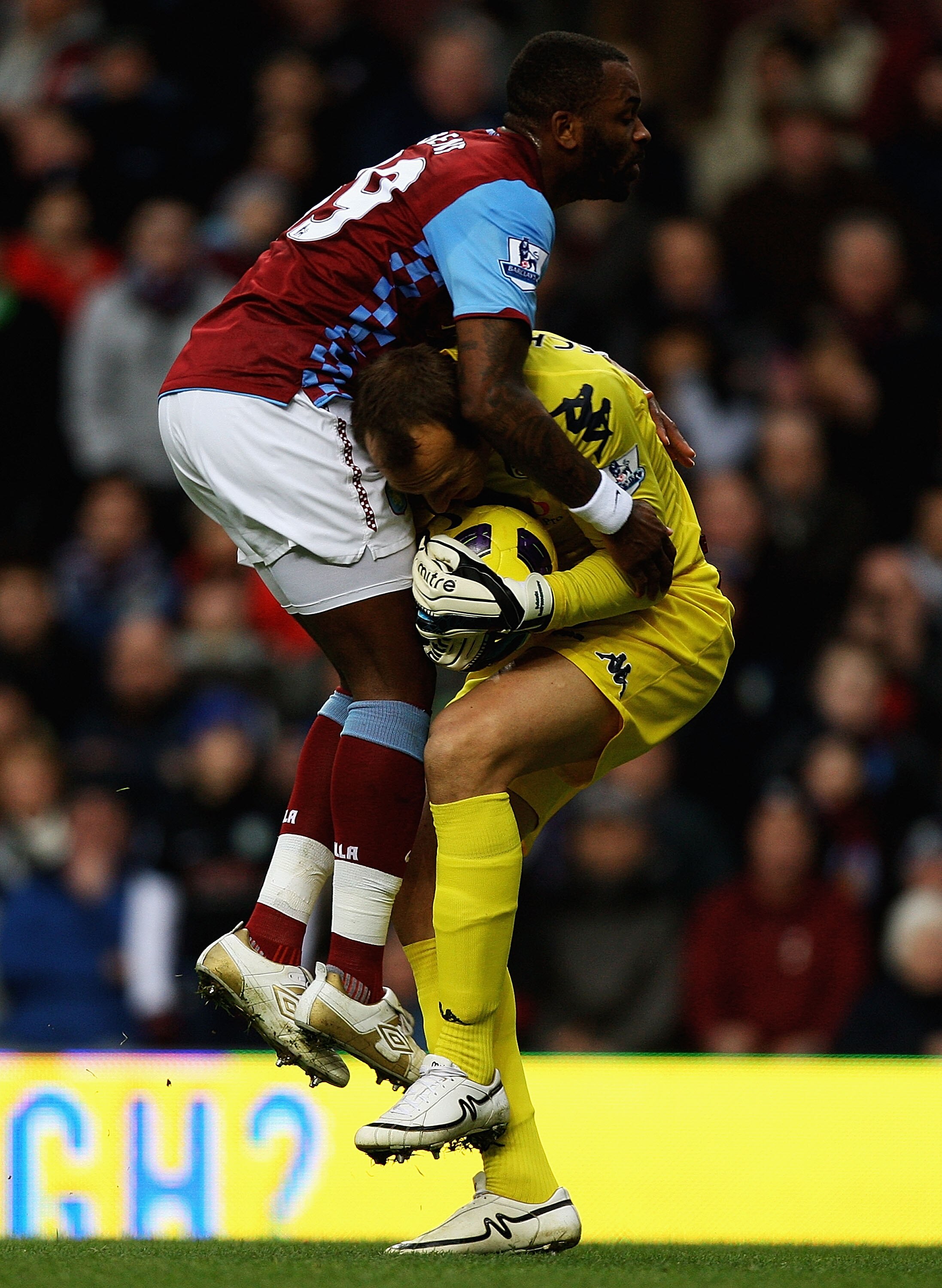 BIRMINGHAM, ENGLAND - FEBRUARY 05:  Darren Bent of Aston Villa and Mark Schwarzer of Fulham collide during the Barclays Premier League match between Aston Villa and Fulham at Villa Park on February 5, 2011 in Birmingham, England.  (Photo by Matthew Lewis/