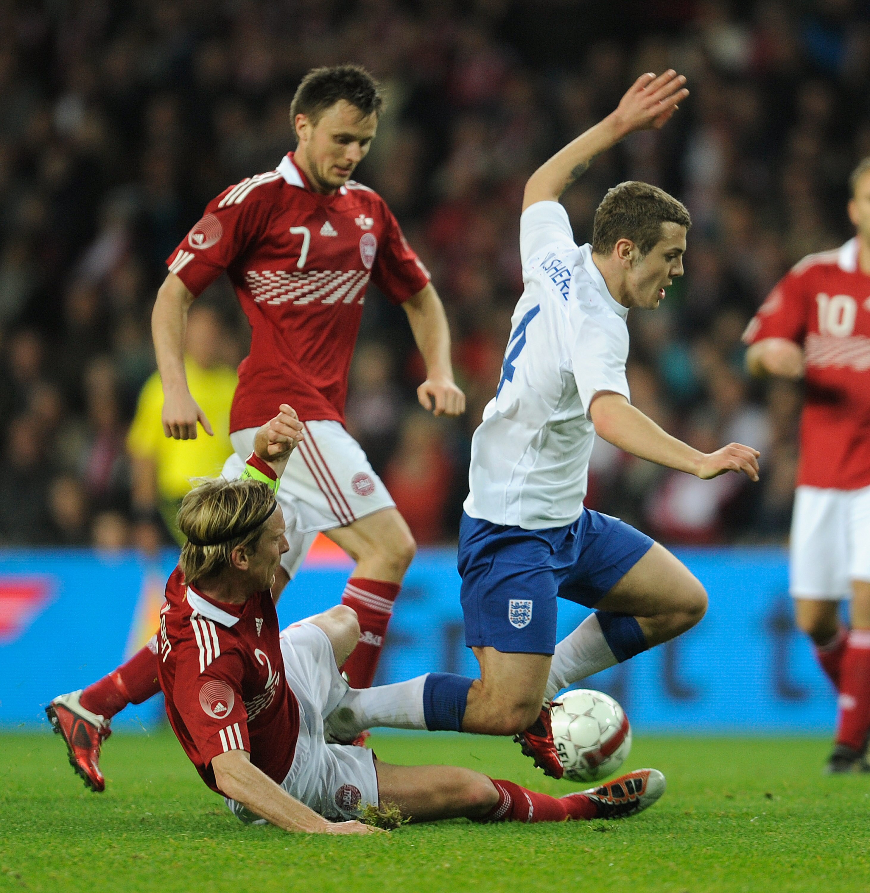 COPENHAGEN, DENMARK - FEBRUARY 09:  Jack Wilshere of England battles Christian Poulsen and William Jorgensen of Denmark during the international friendly match between Denmark and England at Parken Stadium on February 9, 2011 in Copenhagen, .  (Photo by M