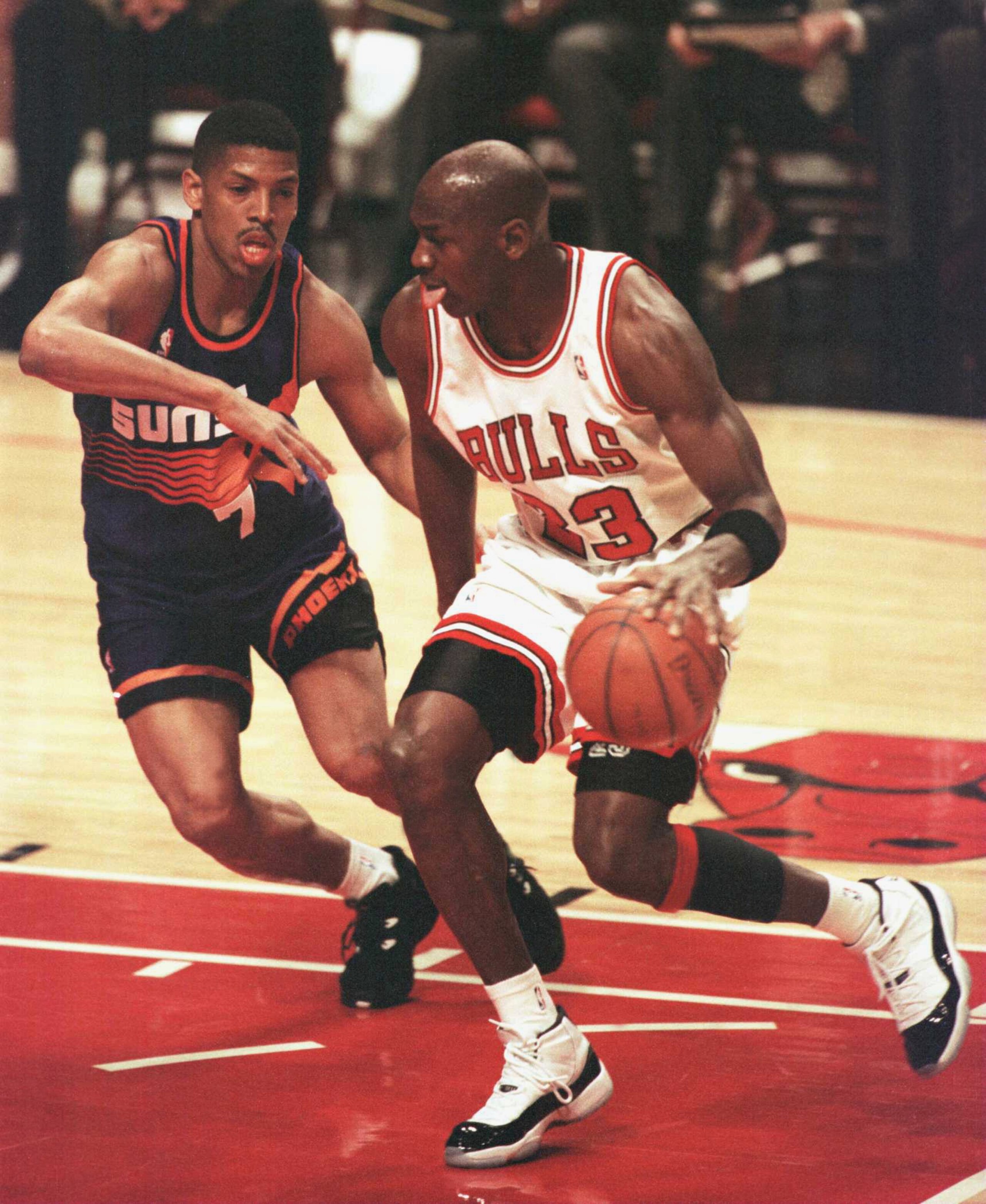 28 Jan 1996: Forward Michael Jordan of the Chicago Bulls drives the lane past guard Kevin Johnson of the Phoenix Suns during first half action of the game at the United Center in Chicago, Illinois. The Bulls went on to beat the Suns 93-82, extending thei 28 Jan 1996: Forward Michael Jordan of the Chicago Bulls drives the lane past guard Kevin Johnson of the Phoenix Suns during first half action of the game at the United Center in Chicago, Illinois. The Bulls went on to beat the Suns 93-82, extending thei