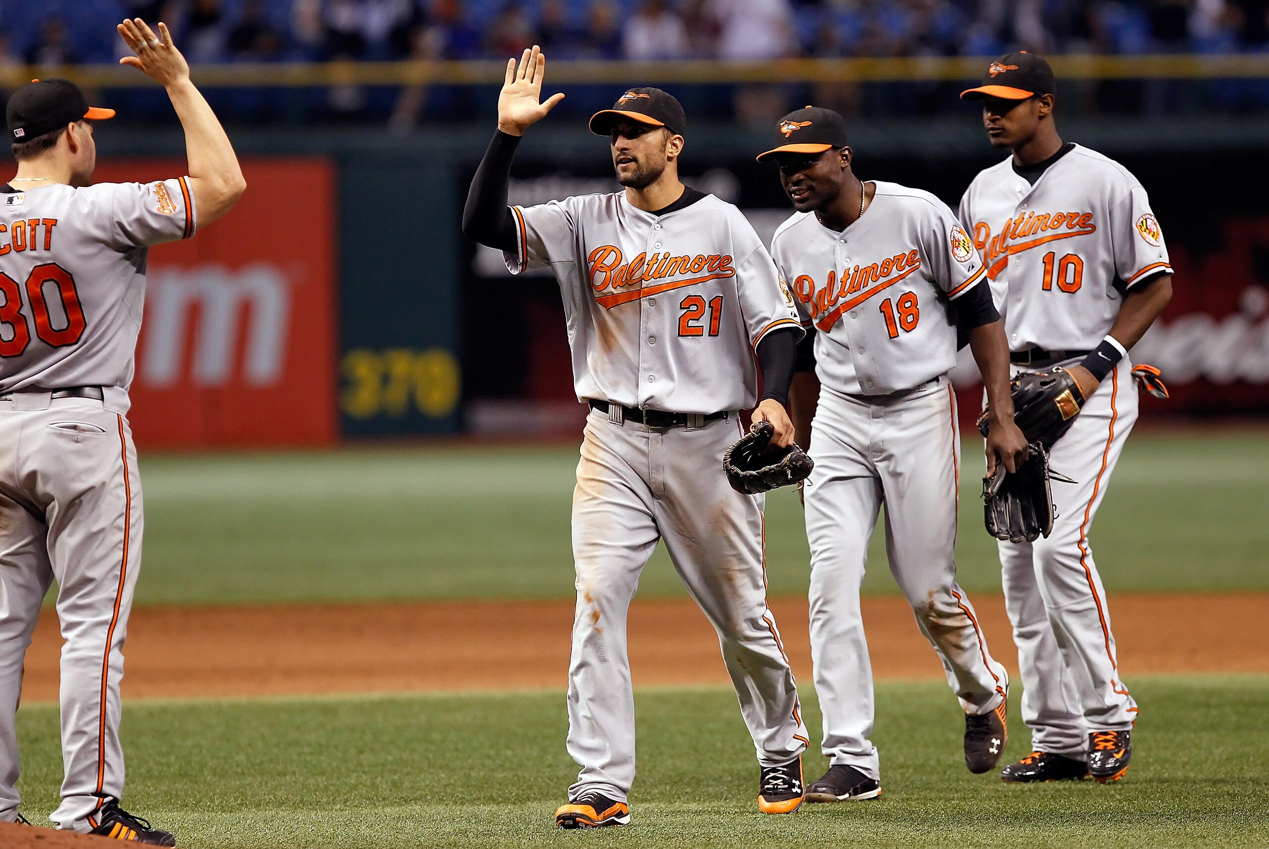ST. PETERSBURG - SEPTEMBER 27:  Nick Markakis #21, Felix Pie #18 and Adam Jones #10 of the Baltimore Orioles celebrate a victory over the Tampa Bay Rays at Tropicana Field on September 27, 2010 in St. Petersburg, Florida.  (Photo by J. Meric/Getty Images)