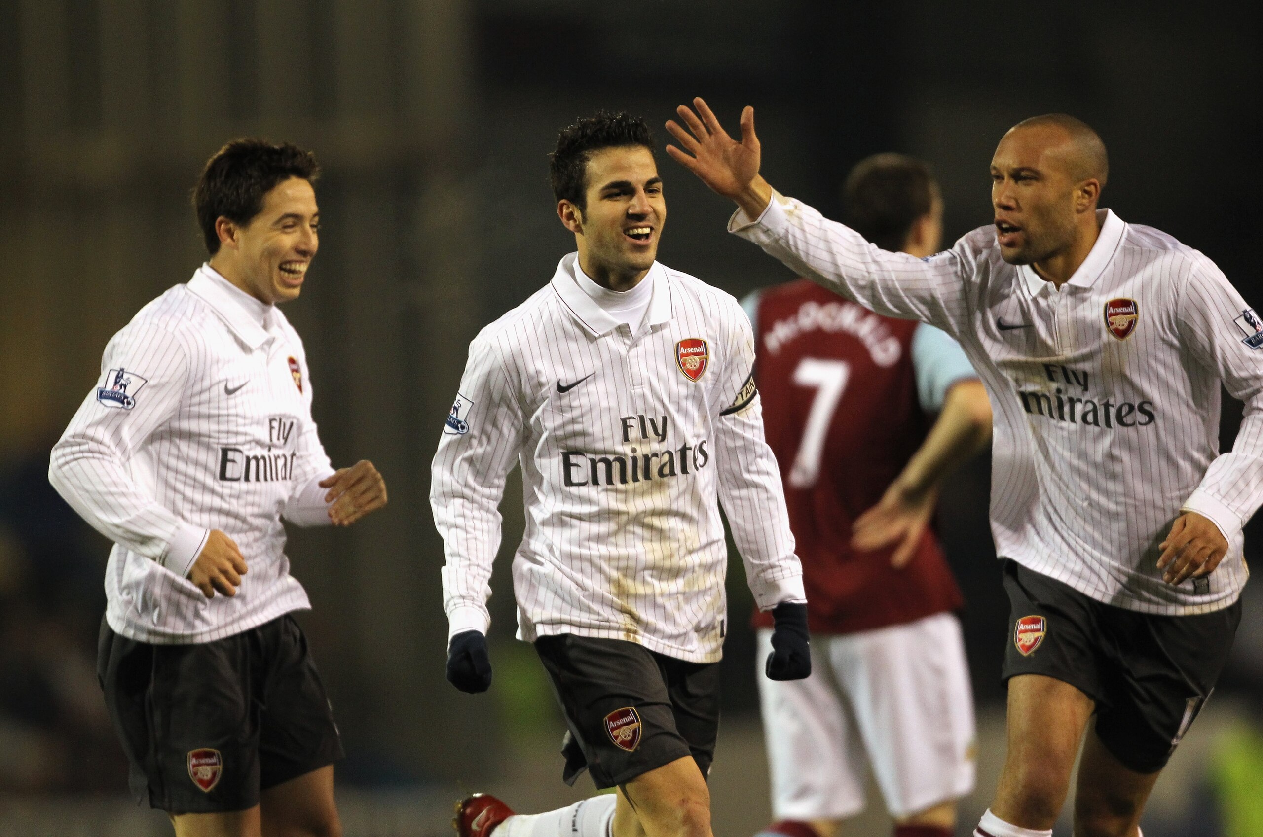 BURNLEY, ENGLAND - DECEMBER 16:  Cesc Fabregas of Arsenal celebrates with Samir Nasri and Mikael Silvestre after scoring the opening goal during the Barclays Premier League match between Burnley and Arsenal at Turf Moor on December 16, 2009 in Burnley, En
