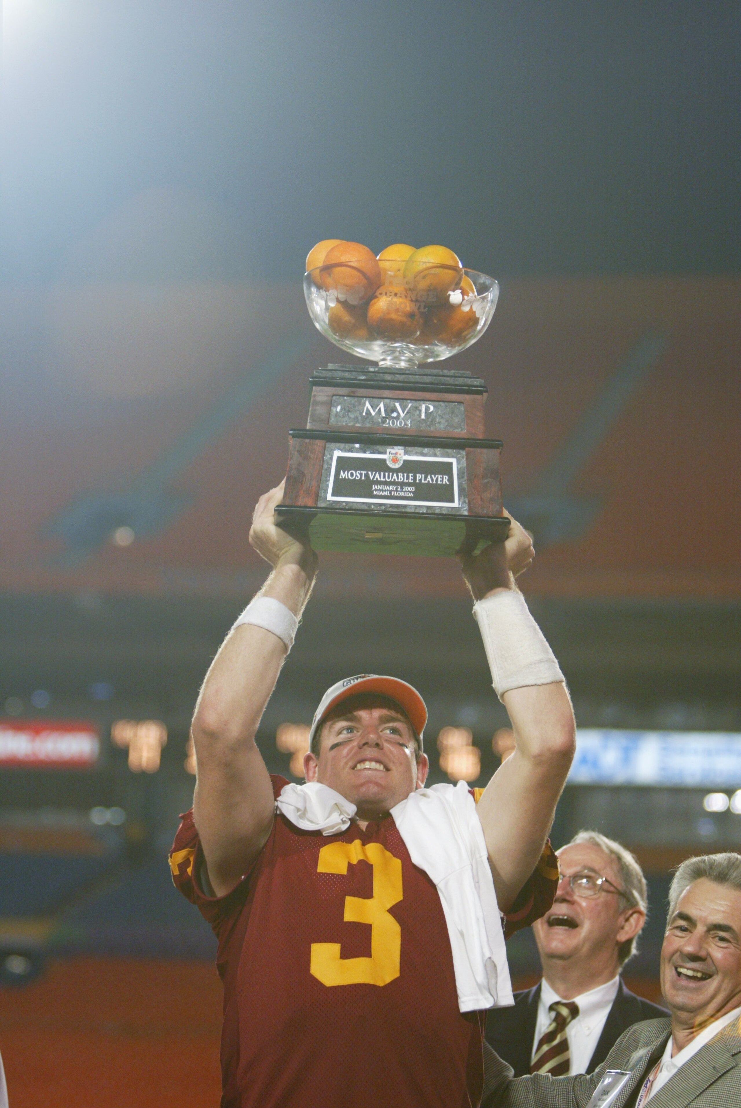 MIAMI - JANUARY 2: Carson Palmer #3 of USC holds aloft the MVP trophy after the victory over Iowa in the FedEx Orange Bowl on January 2, 2003 at Pro Player Stadium in Miami, Florida. Palmer led scoring drives of 79, 80, 99, 85 and 61 yards as USC defeat MIAMI - JANUARY 2: Carson Palmer #3 of USC holds aloft the MVP trophy after the victory over Iowa in the FedEx Orange Bowl on January 2, 2003 at Pro Player Stadium in Miami, Florida. Palmer led scoring drives of 79, 80, 99, 85 and 61 yards as USC defeat
