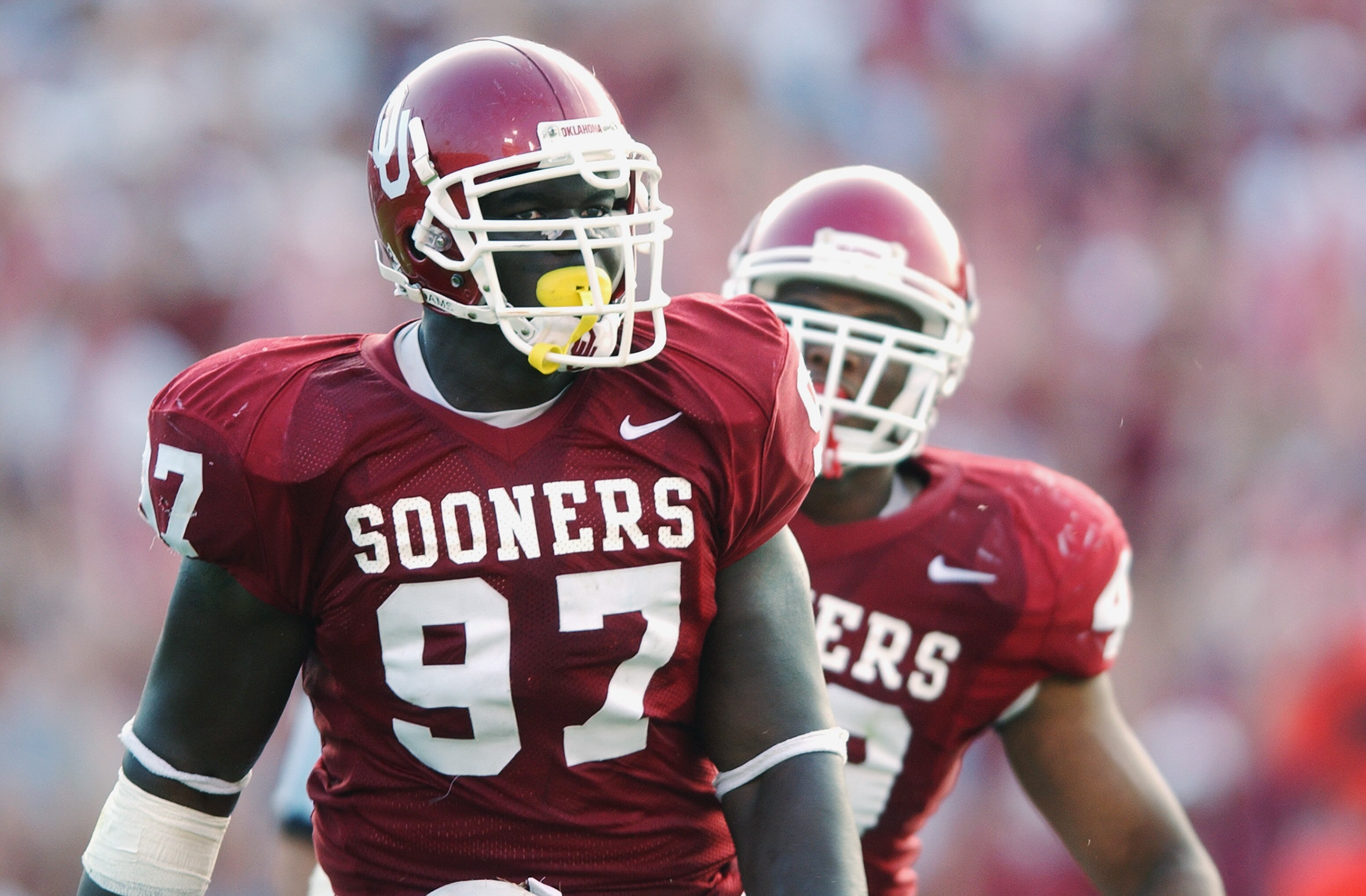 DALLAS - OCTOBER 12:  Defensive lineman Tommie Harris #97 of the Oklahoma Sooners stands on the field during the Red River Shootout against the Texas Longhorns at the Cotton Bowl on October 12, 2002 in Dallas, Texas.  Oklahoma won 35-24.  (Photo by Harry