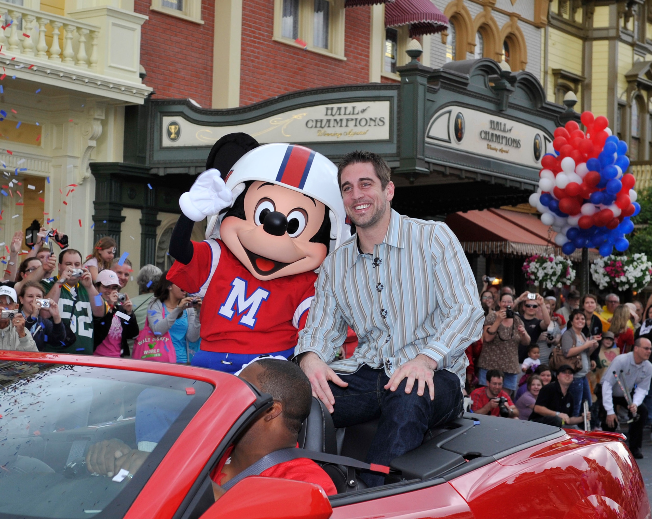 LAKE BUENA VISTA, FL - FEBRUARY 07:  In this handout photo provided by Disney, Super Bowl XLV Most Valuable Player Aaron Rodgers takes a celebratory ride with Mickey Mouse, following the Green Bay Packers' 31-25 victory over the Pittsburgh Steelers Februa