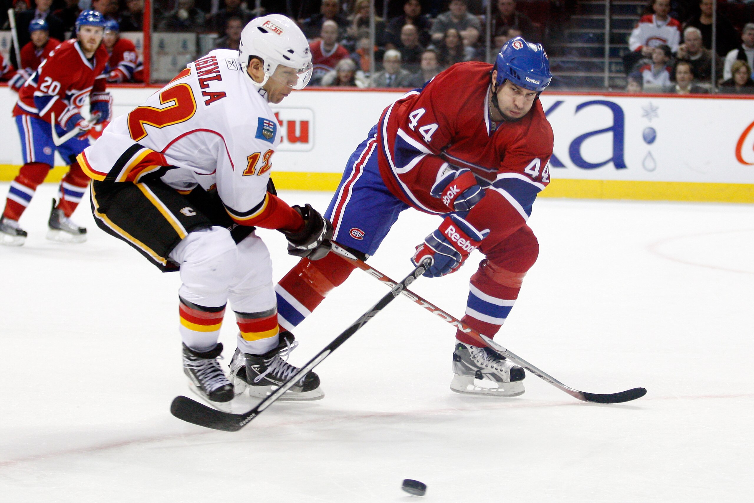 MONTREAL, CANADA - JANUARY 17:  Roman Hamrlik #44 of the Montreal Canadiens strips the puck from Jarome Iginla #12 of the Calgary Flames during the NHL game at the Bell Centre on January 17, 2011 in Montreal, Quebec, Canada.  The Canadiens defeated the Fl