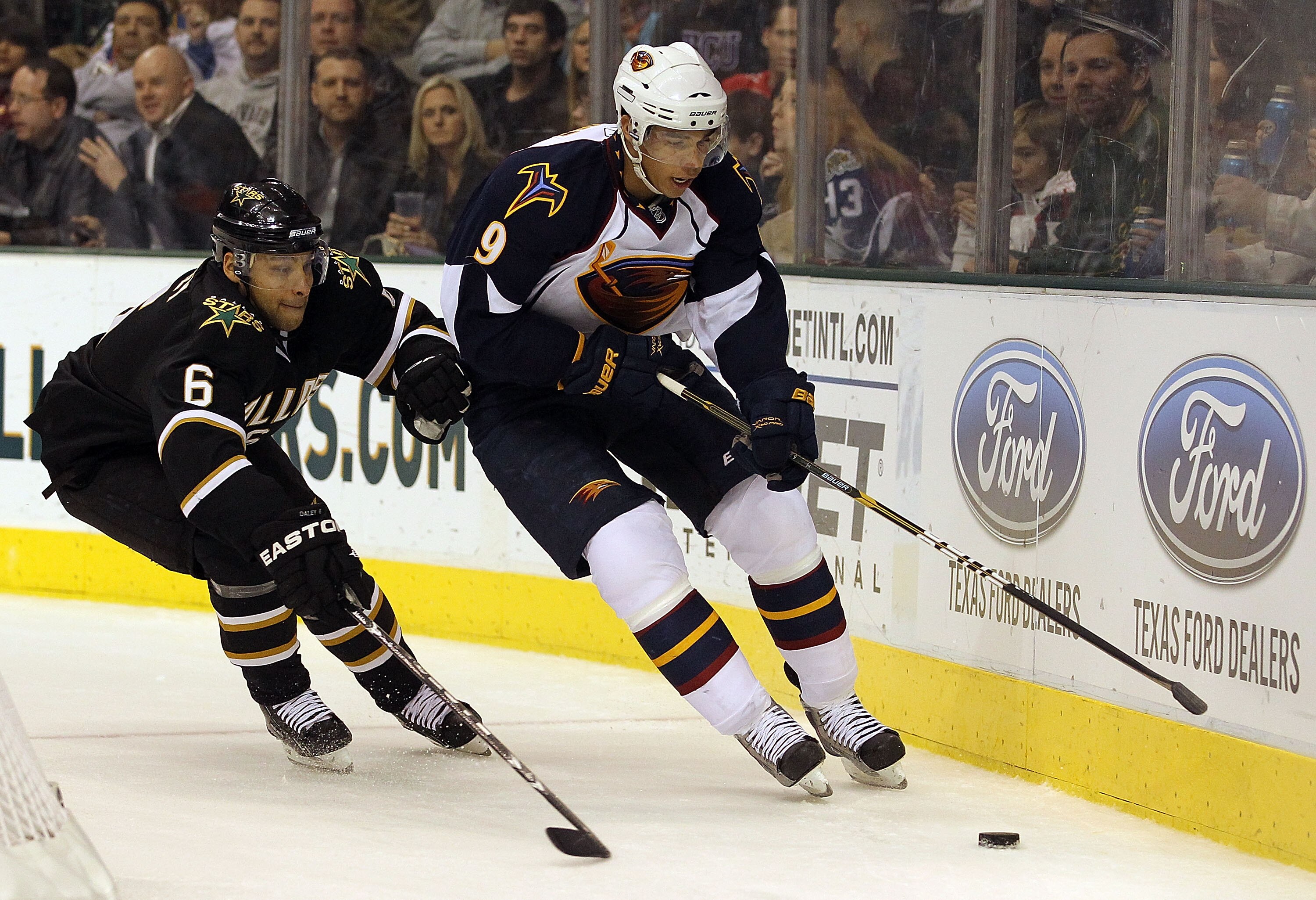 DALLAS, TX - JANUARY 15:  Evander Kane #9 of the Atlanta Thrashers skates the puck against Trevor Daley #6 of the Dallas Stars at American Airlines Center on January 15, 2011 in Dallas, Texas.  (Photo by Ronald Martinez/Getty Images)
