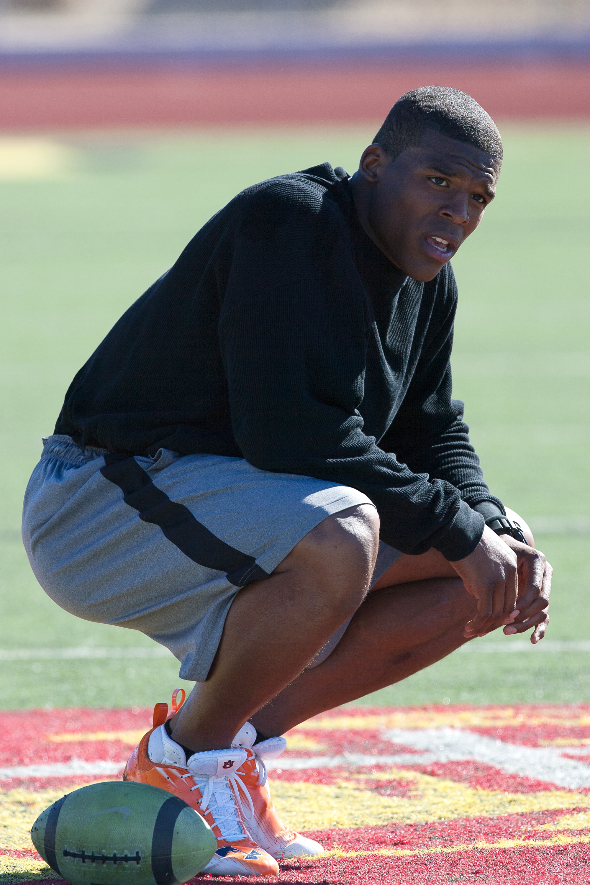 SAN DIEGO, CA - FEBRUARY 10: 2010 Heisman Trophy winning quarterback Cam Newton of Auburn pauses during his workout routine for the media at Cathedral High School's sports stadium on February 10, 2011 in San Diego, California. (Photo by Kent Horner/ Getty
