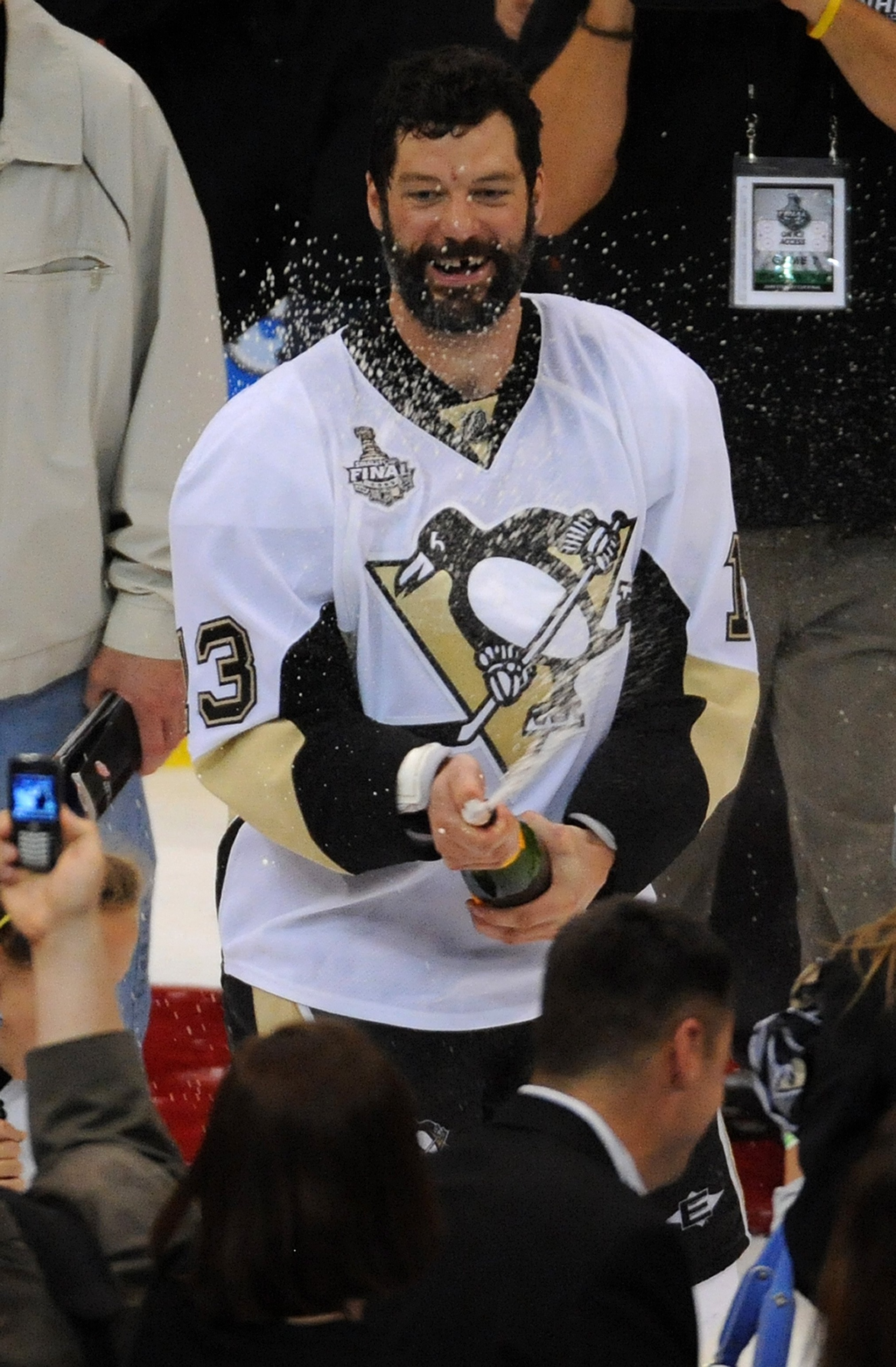 DETROIT - JUNE 12:  Bill Guerin #13 of the Pittsburgh Penguins sprays sparkling wine after Game Seven of the 2009 NHL Stanley Cup Finals against the Detroit Red Wings at Joe Louis Arena on June 12, 2009 in Detroit, Michigan. The Penguins defeated the Red