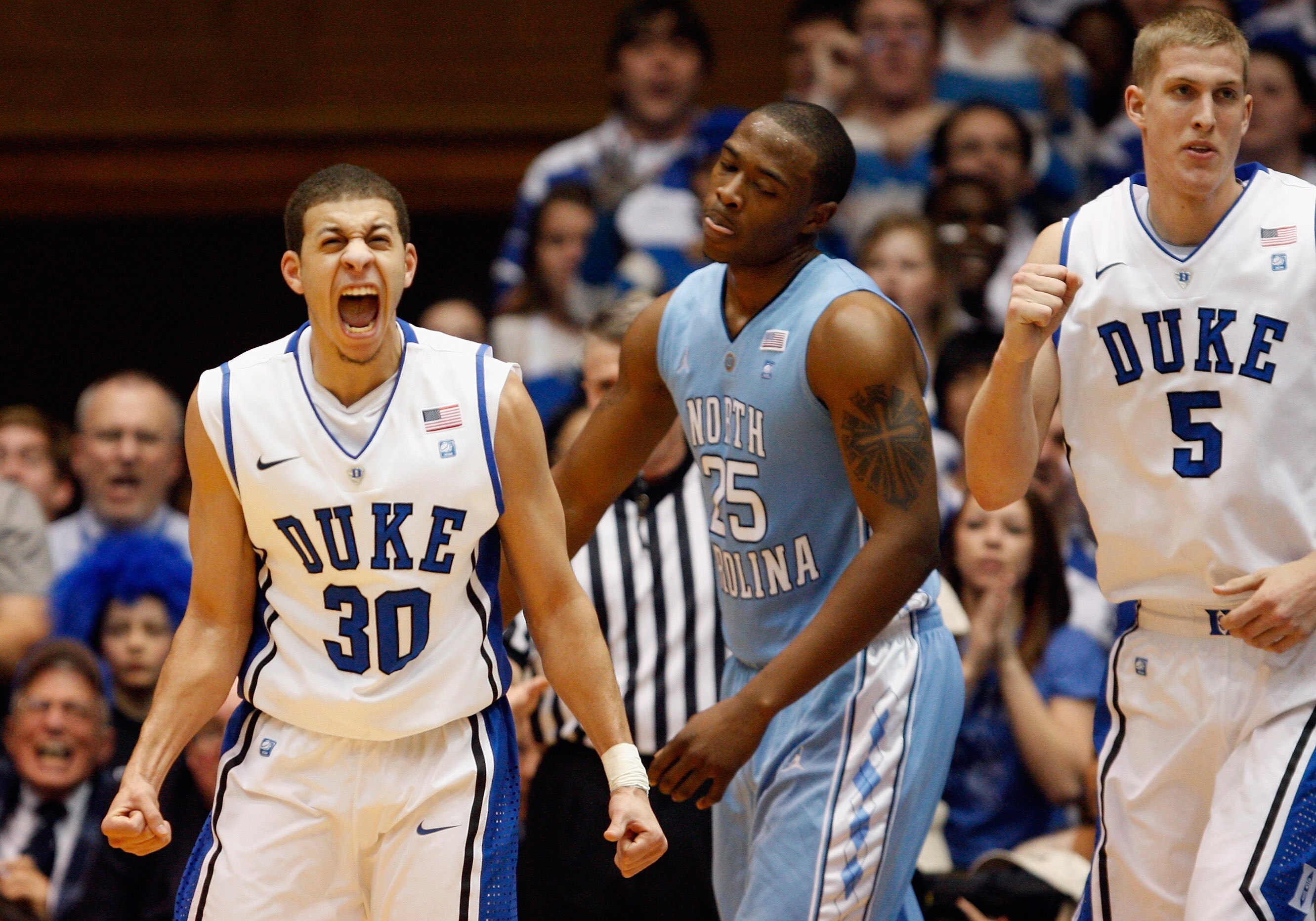 DURHAM, NC - FEBRUARY 09:  Seth Curry #30 of the Duke Blue Devils celebrates with teammate Mason Plumlee #5 after defeating the North Carolina Tar heels 79-73 as Justin Knox looks on during their game at Cameron Indoor Stadium on February 9, 2011 in Durha