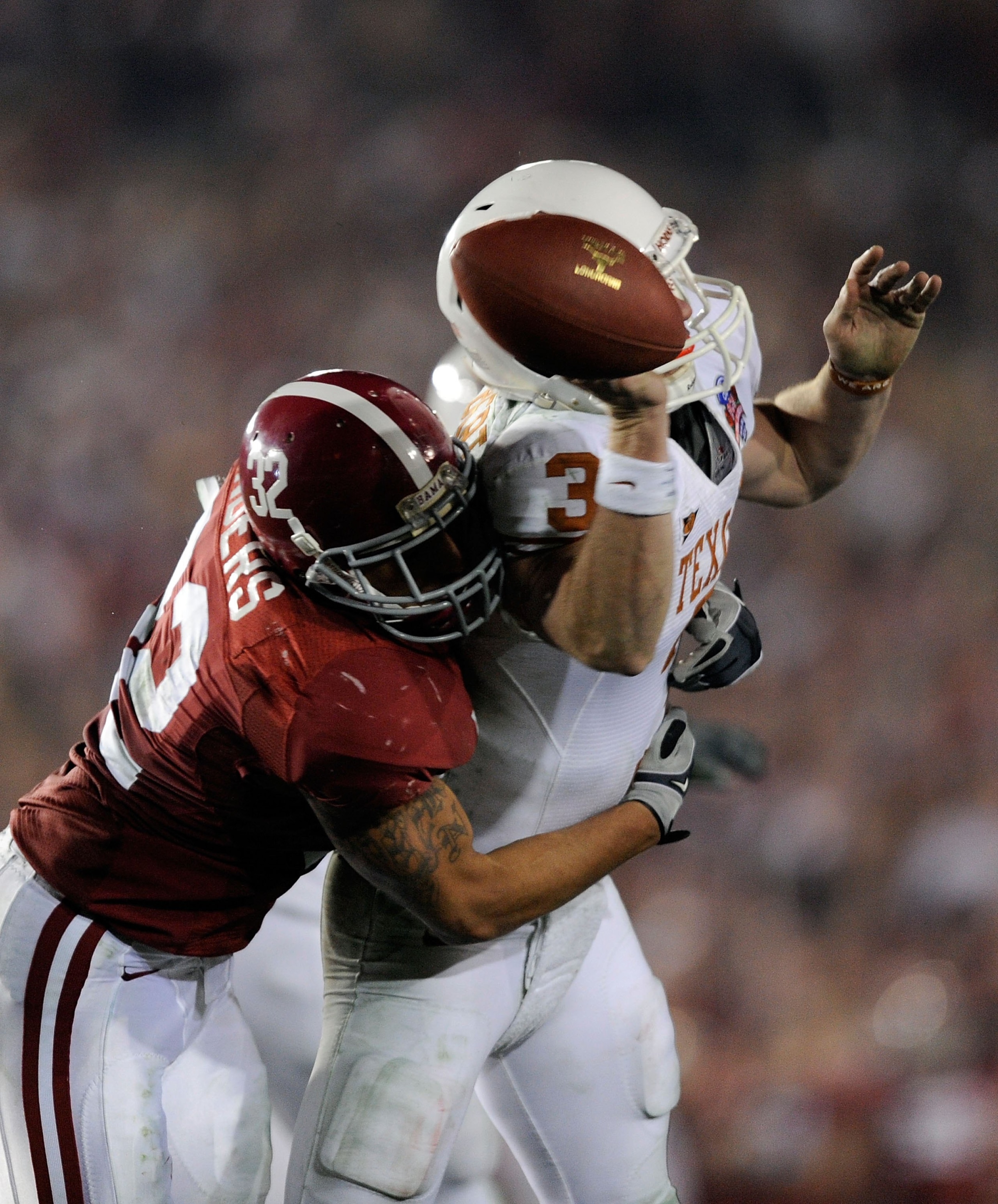 PASADENA, CA - JANUARY 07:  Quarterback Garrett Gilbert #3 of the Texas Longhorns fumbles the ball as he is hit by linebacker Eryk Anders #32 of the Alabama Crimson Tide during the Citi BCS National Championship game at the Rose Bowl on January 7, 2010 in