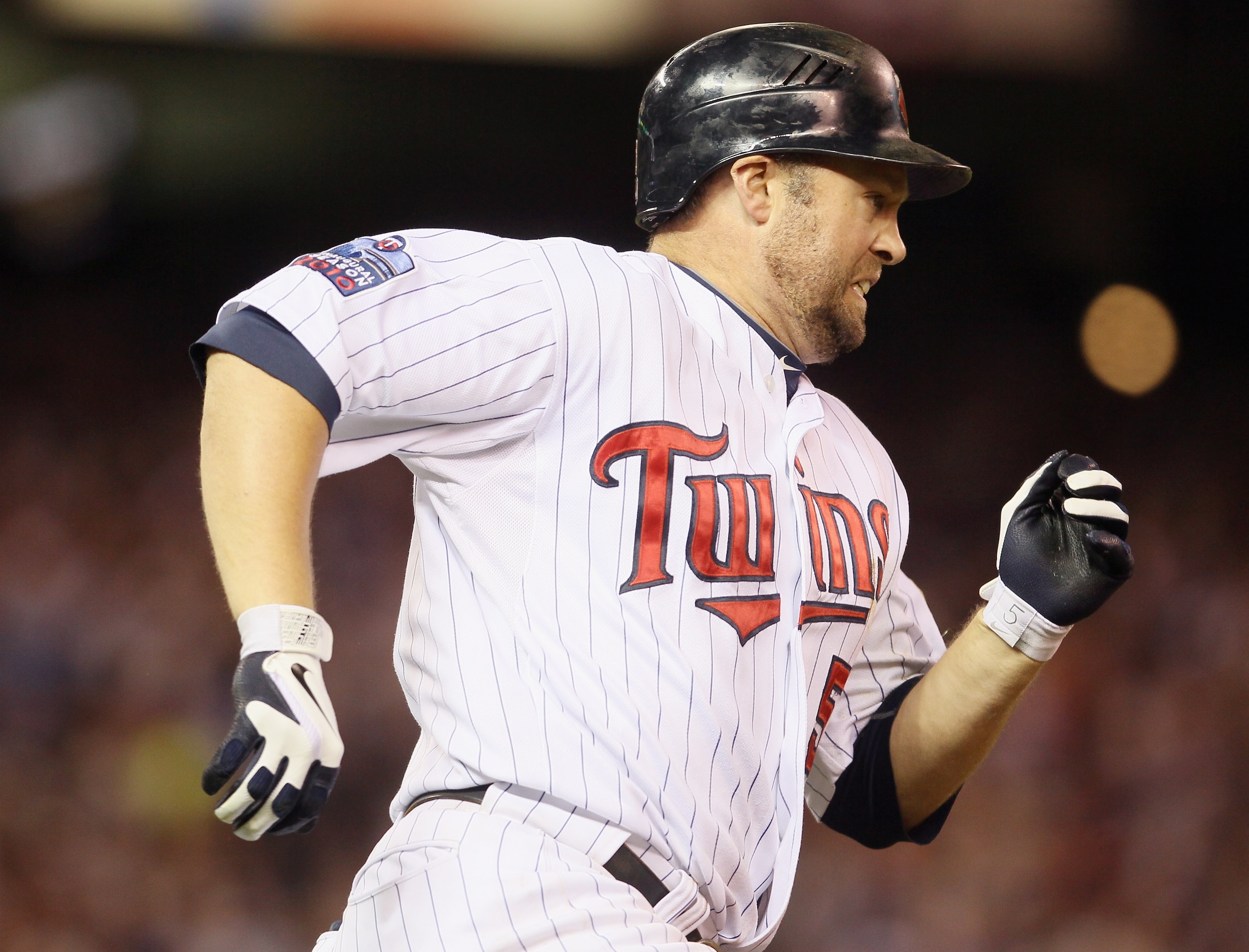 MINNEAPOLIS - OCTOBER 06:  Michael Cuddyer #5 of the Minnesota Twins heads to first in the sixth inning against the New York Yankees during game one of the ALDS on October 6, 2010 at Target Field in Minneapolis, Minnesota.  (Photo by Elsa/Getty Images)