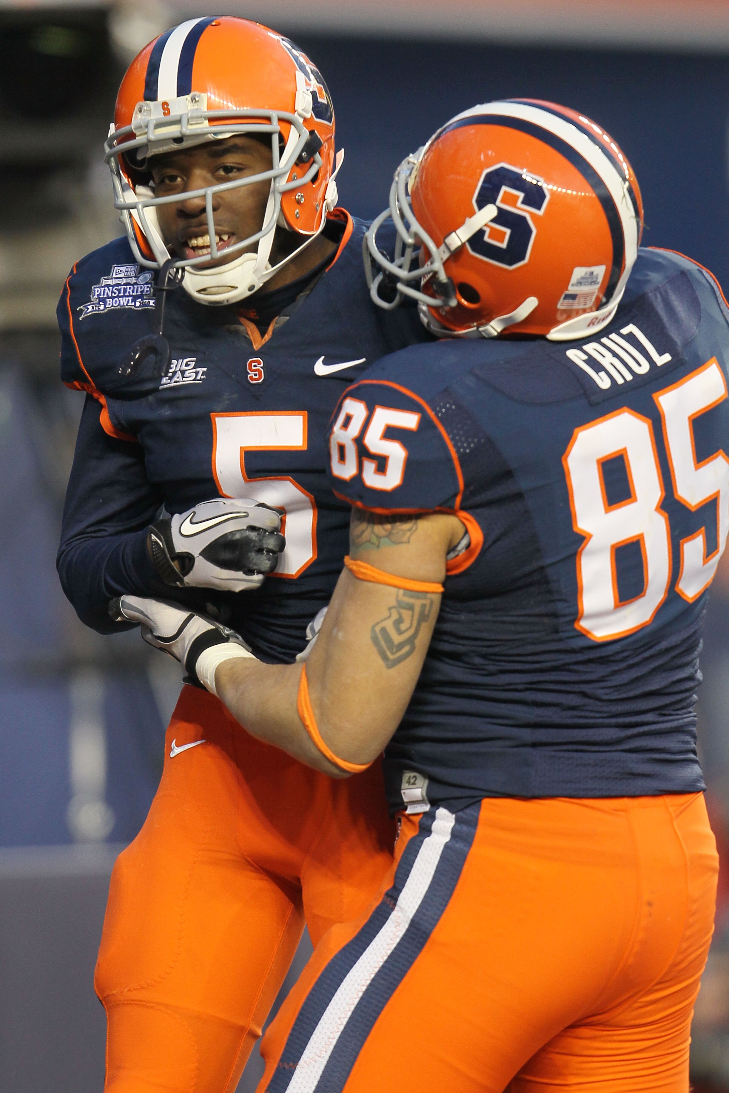 NEW YORK, NY - DECEMBER 30: Marcus Sales #5 of the Syracuse Orange is congratulated by team mate Jose Cruz #85 after scoring a touchdown against  the Kansas State Wildcats during the New Era Pinstripe Bowl at Yankee Stadium on December 30, 2010 in New Yor