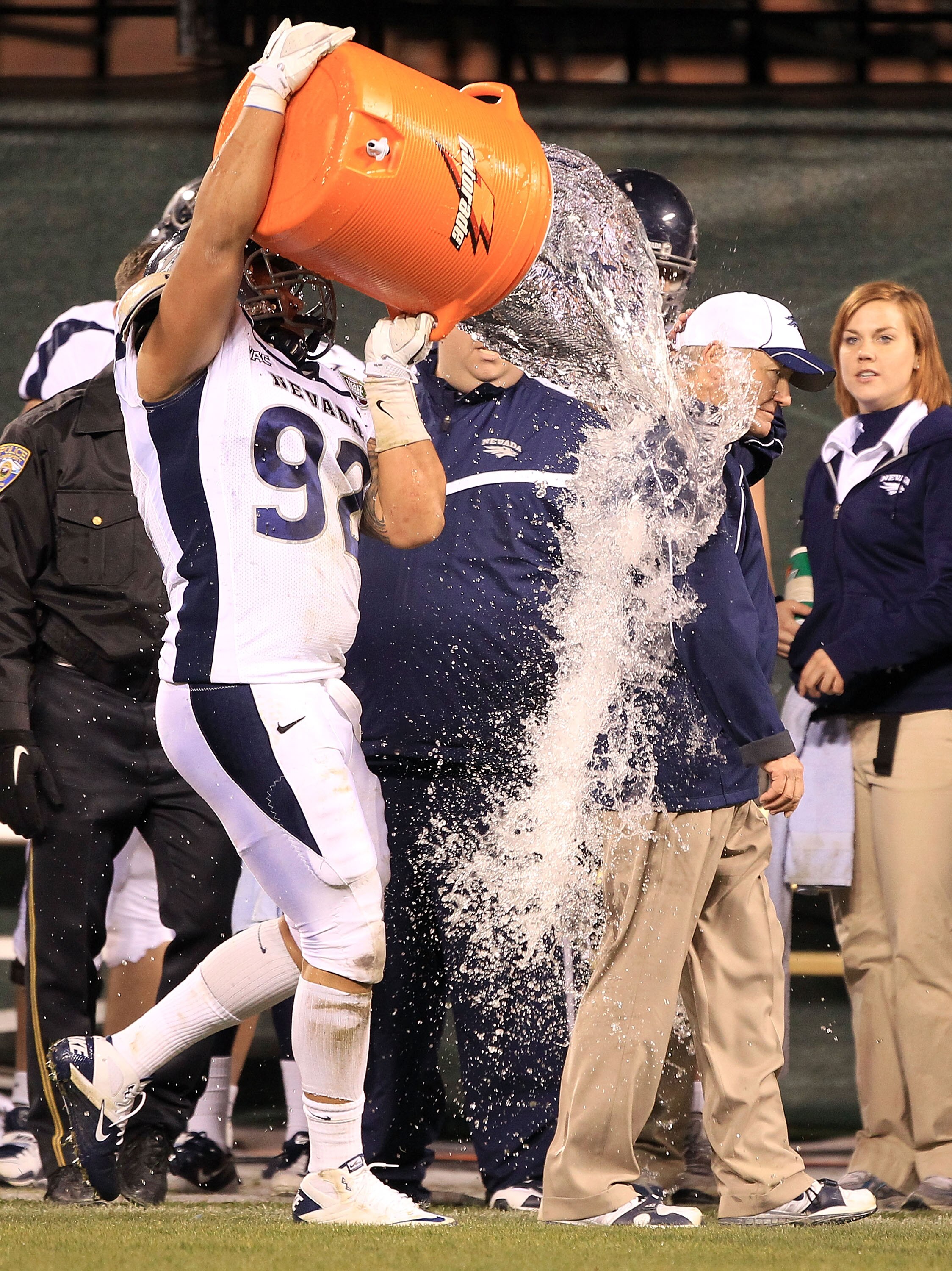 SAN FRANCISCO, CA - JANUARY 09:  Head coach Chris Ault of the Nevada Wolf Pack is covered in water by Mike Andrews #92  in the closing minute of their victory over Boston College in the Kraft Fight Hunger Bowl at AT&T Park on January 9, 2011 in San Franci